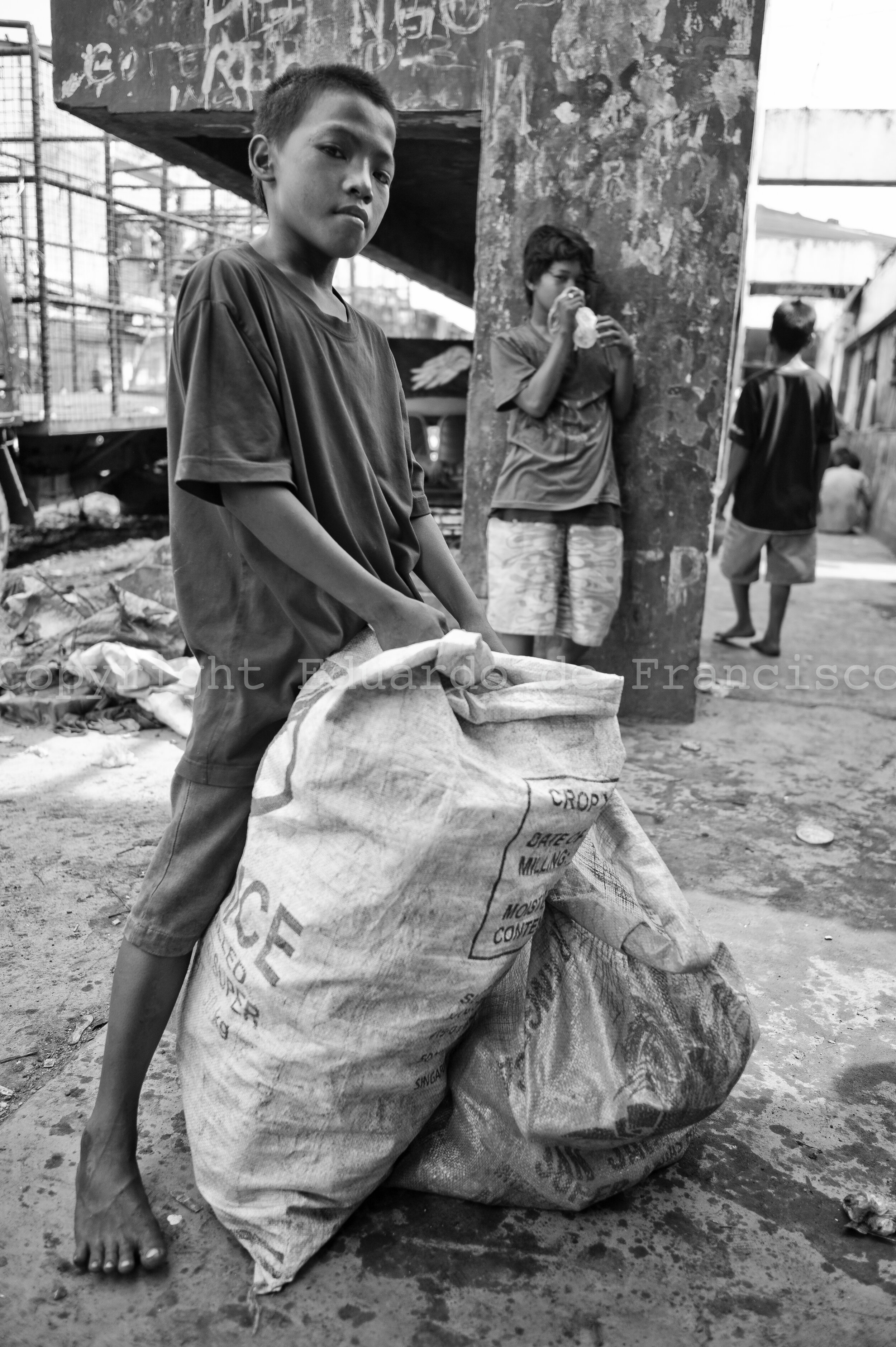  Romel (left), 12 years old. He has 7 brothers and sisters, and lives with his mother and step-father (his father died). He collects rubbish and earns 100 pesos (2 euro) per day. Like most of children of his age, he inhales three bags of glue every d