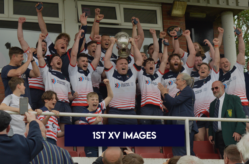 Aldwinians 1st XV celebrating on a podium with a trophy