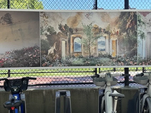Photography exhibition called “Photoville” showing on huge banners on the side of Chelsea Park 