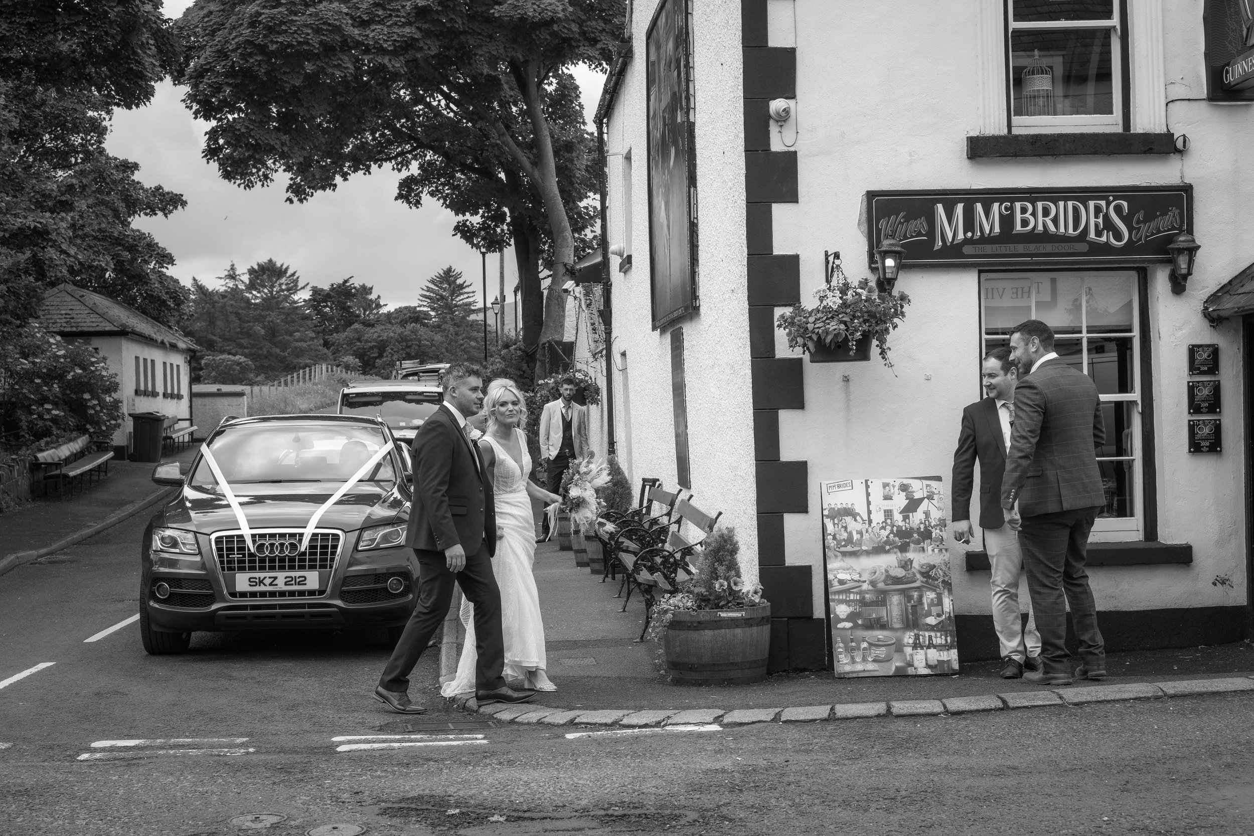 Bride and Groom walking into McBride's pub