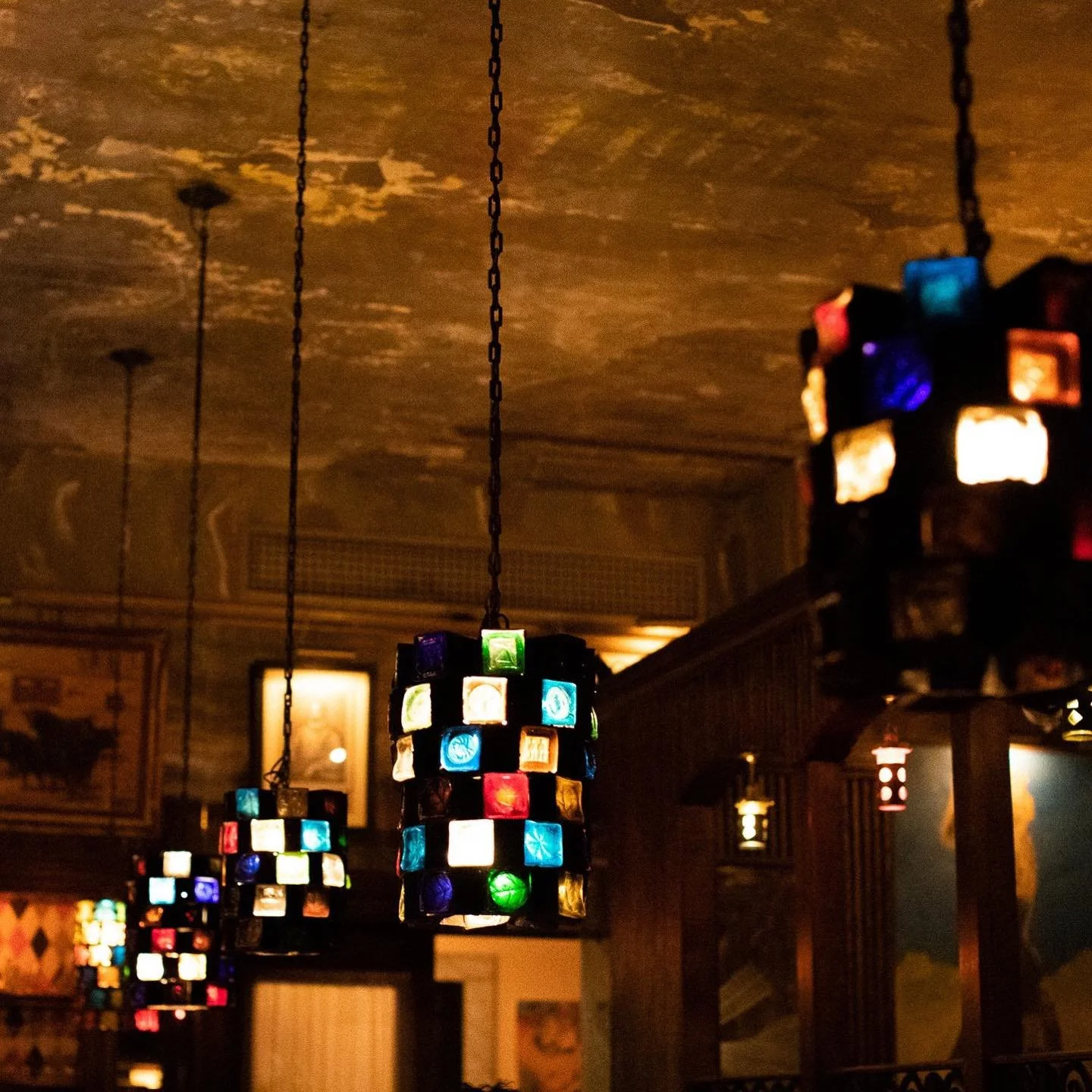 NYC restaurant El Quijote showing historic ceiling, booth seating, four tops, and vintage french chandelier pendant lights. Hospitality interior design and consultancy by Studio Sio, New Zealand