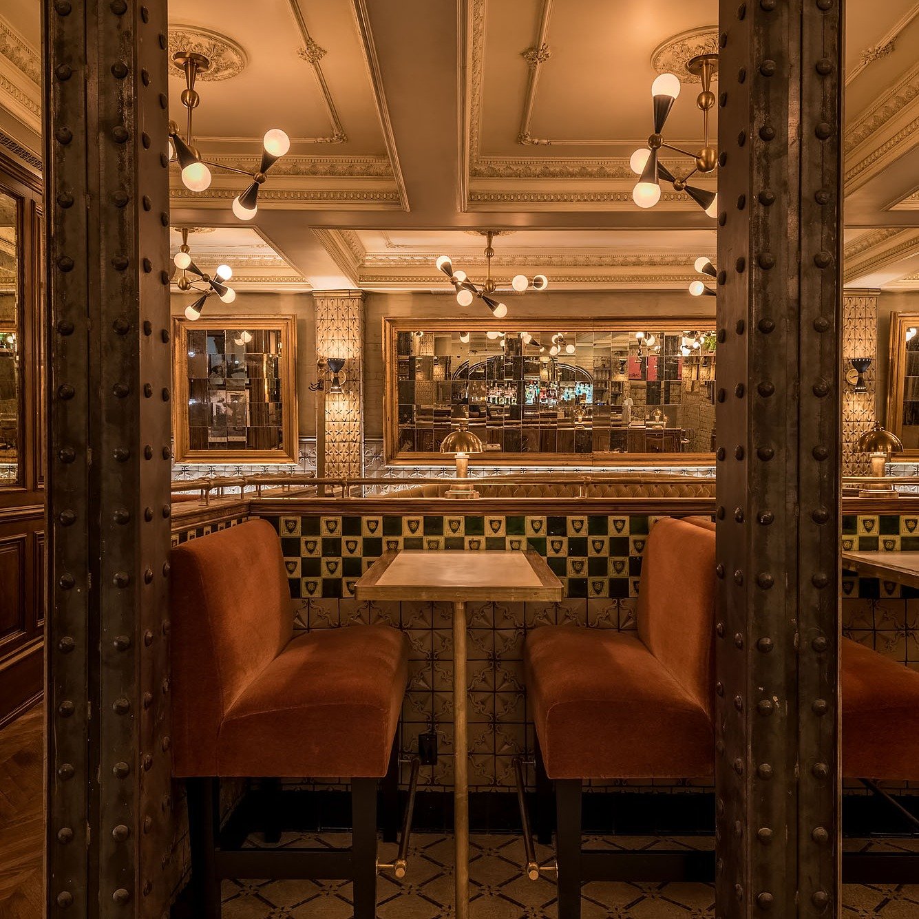 Velvet, tile, iron, glass.

This Barbette booth pulls its weight&mdash;visually and emotionally. Framed by riveted steel columns and layered with custom tile and warm velvet, it&rsquo;s a place built for long dinners and low lighting. Design that hol