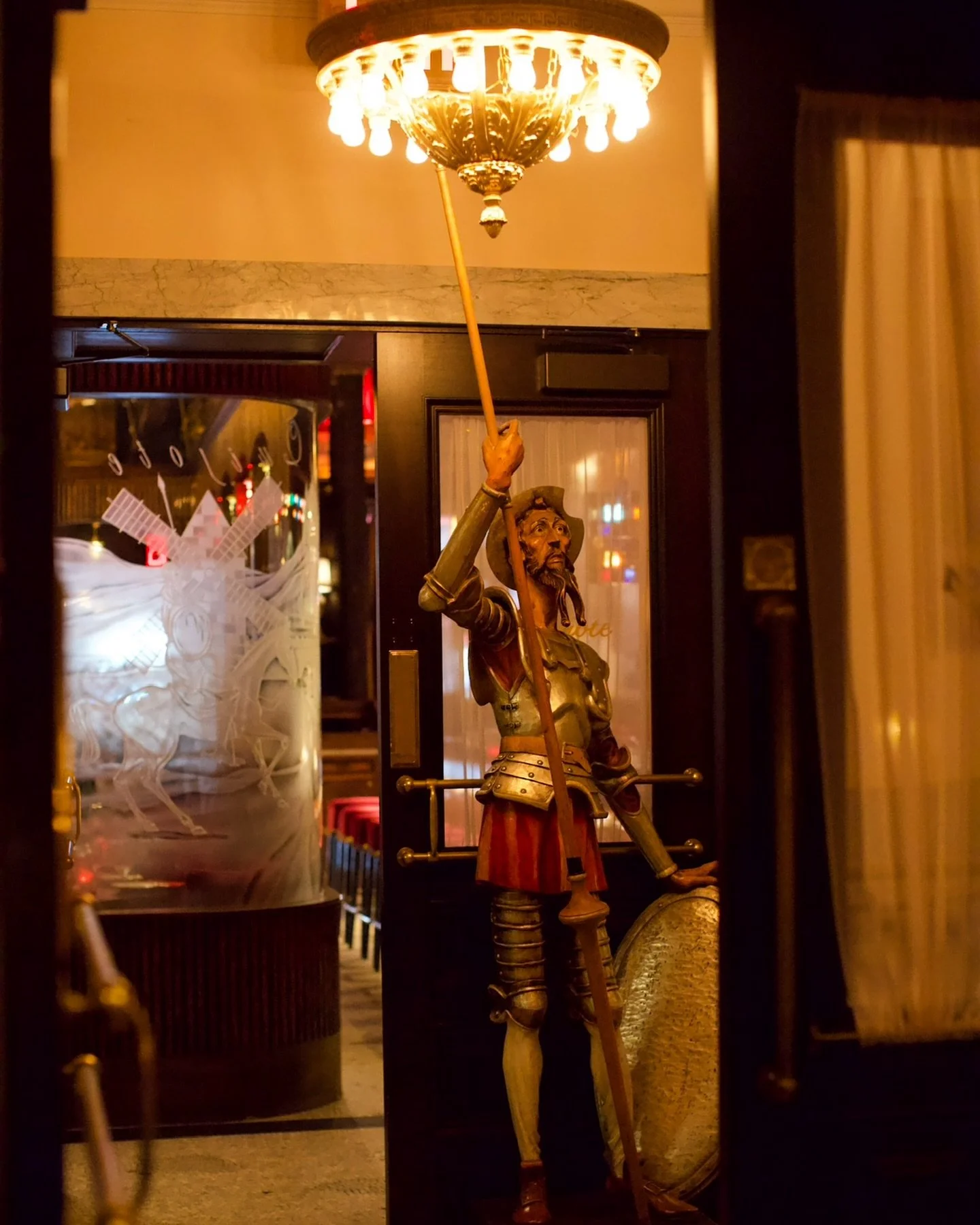 NYC restaurant El Quijote showing historic ceiling, booth seating, four tops, and vintage french chandelier pendant lights. Hospitality interior design and consultancy by Studio Sio, New Zealand