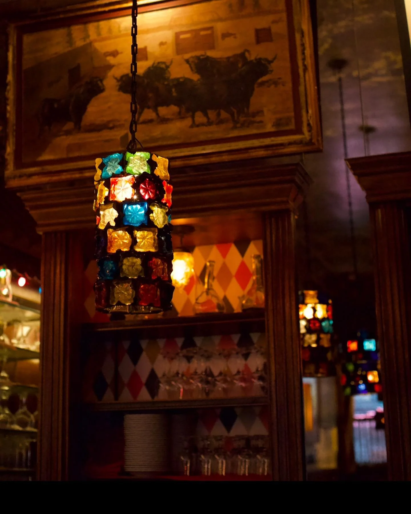 NYC restaurant El Quijote showing historic ceiling, booth seating, four tops, and vintage french chandelier pendant lights. Hospitality interior design and consultancy by Studio Sio, New Zealand