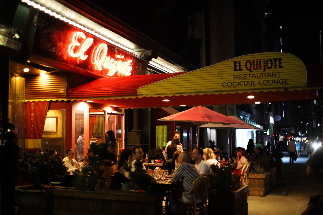 NYC restaurant El Quijote showing historic ceiling, booth seating, four tops, and vintage french chandelier pendant lights. Hospitality interior design and consultancy by Studio Sio, New Zealand
