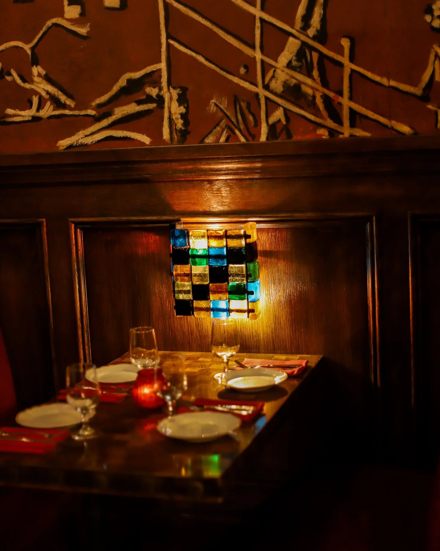 NYC restaurant El Quijote showing historic ceiling, booth seating, four tops, and vintage french chandelier pendant lights. Hospitality interior design and consultancy by Studio Sio, New Zealand