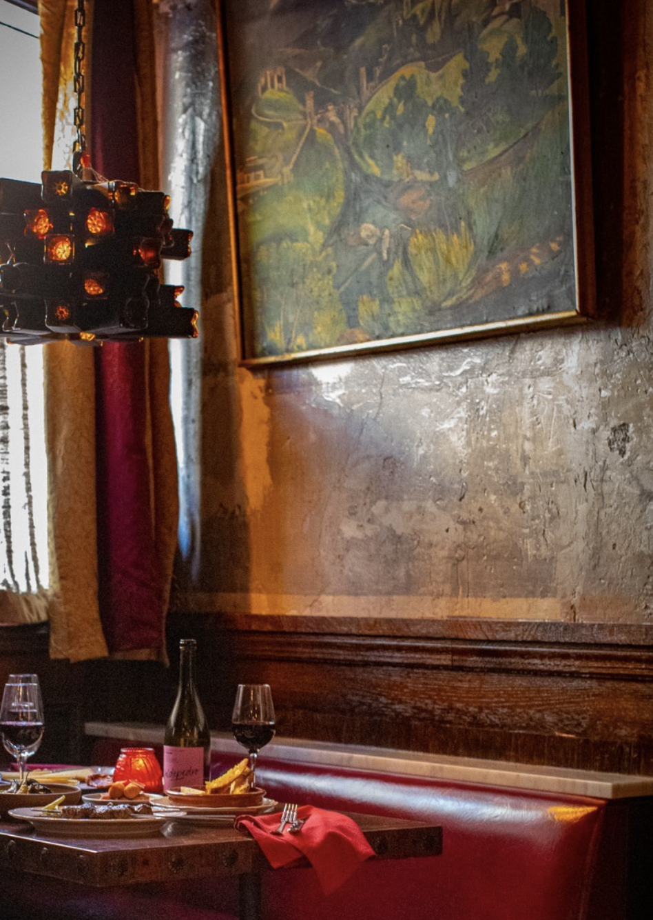 NYC restaurant El Quijote showing historic ceiling, booth seating, four tops, and vintage french chandelier pendant lights. Hospitality interior design and consultancy by Studio Sio, New Zealand