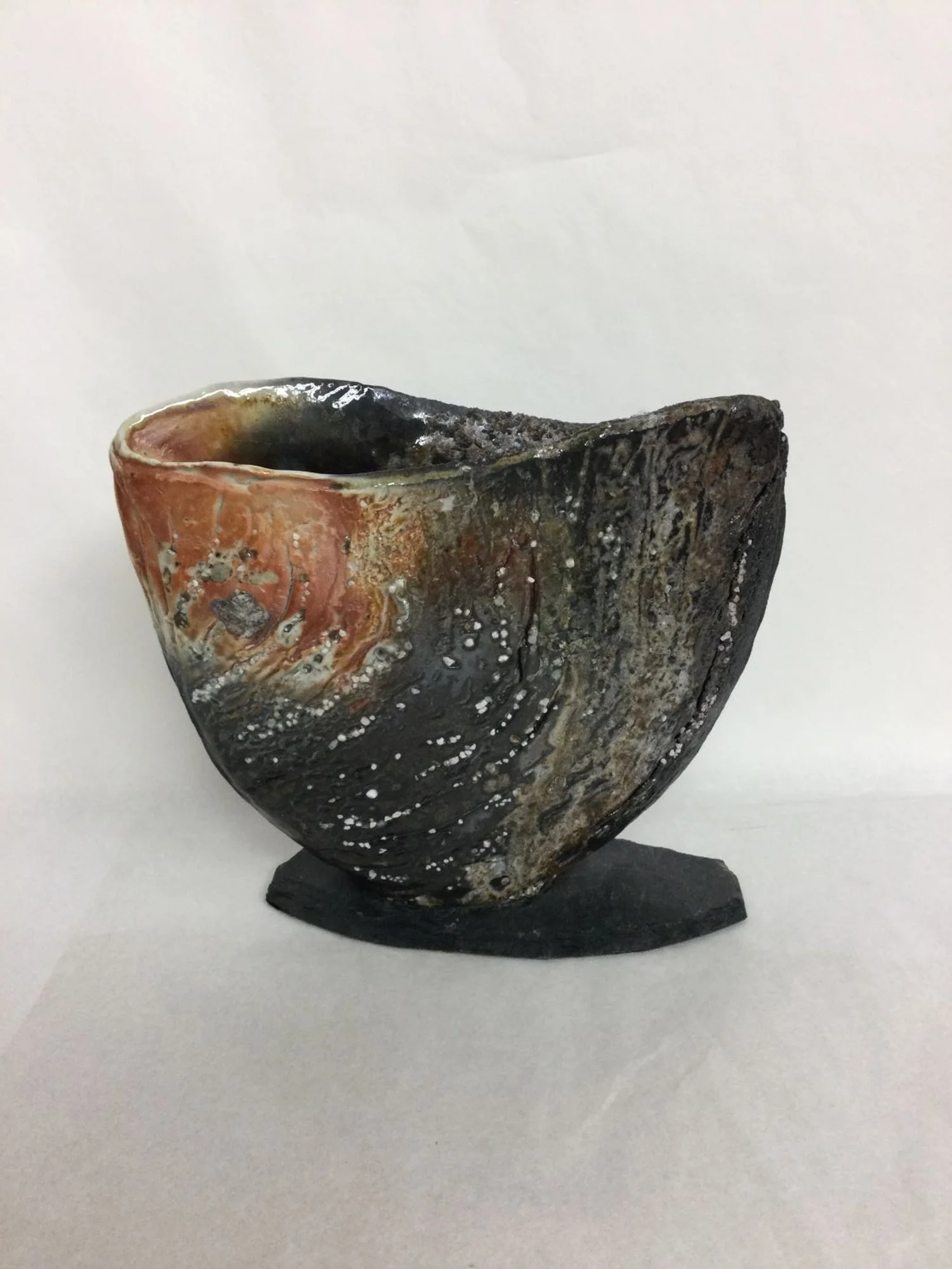 Vase/Object XXV-II, 2025, porcelain slab with slate base, studded with inclusions of natural materials, wood-fired, 6 x 7 x 2.25 inches (15 x 17.5 x 5.5 cm), $420 Cdn.