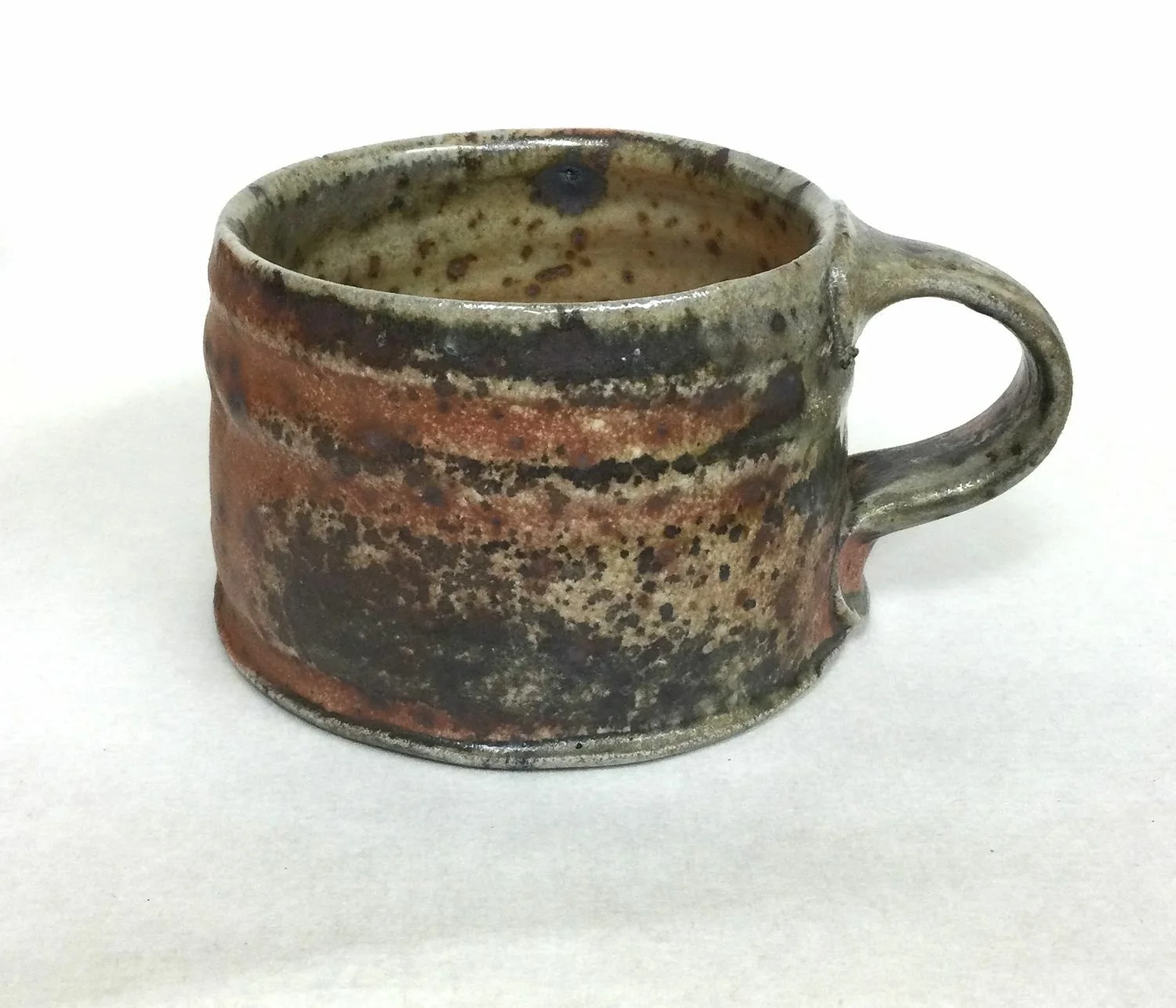 Natural Ash Glazed Mug (#25.4), 2025, woodfired porcelain, 2.5 x 3.5 x 4.25 inches (6 x 9 x 10.5 cm) $75 Cdn.
