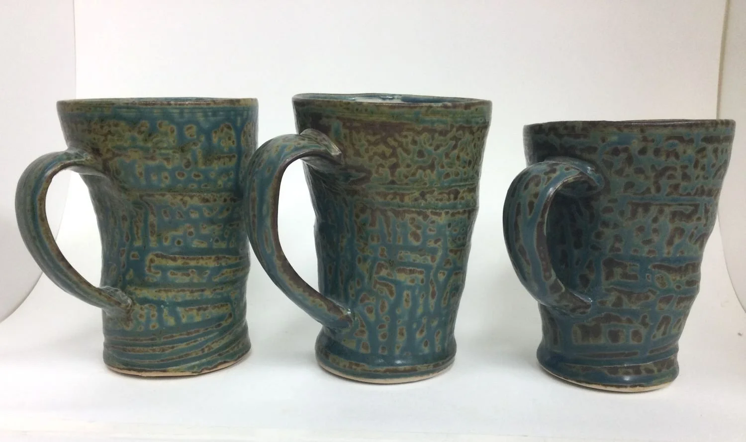 Reduction Fired Medium Sized Mugs (#26.6.36tuy), 2026, reduction fired porcelain, 4.5 x 4 x 3.25 inches (11.5 x 10 x 8.5 inches) $45 Cdn each (#1-t available), #2,3 sold).