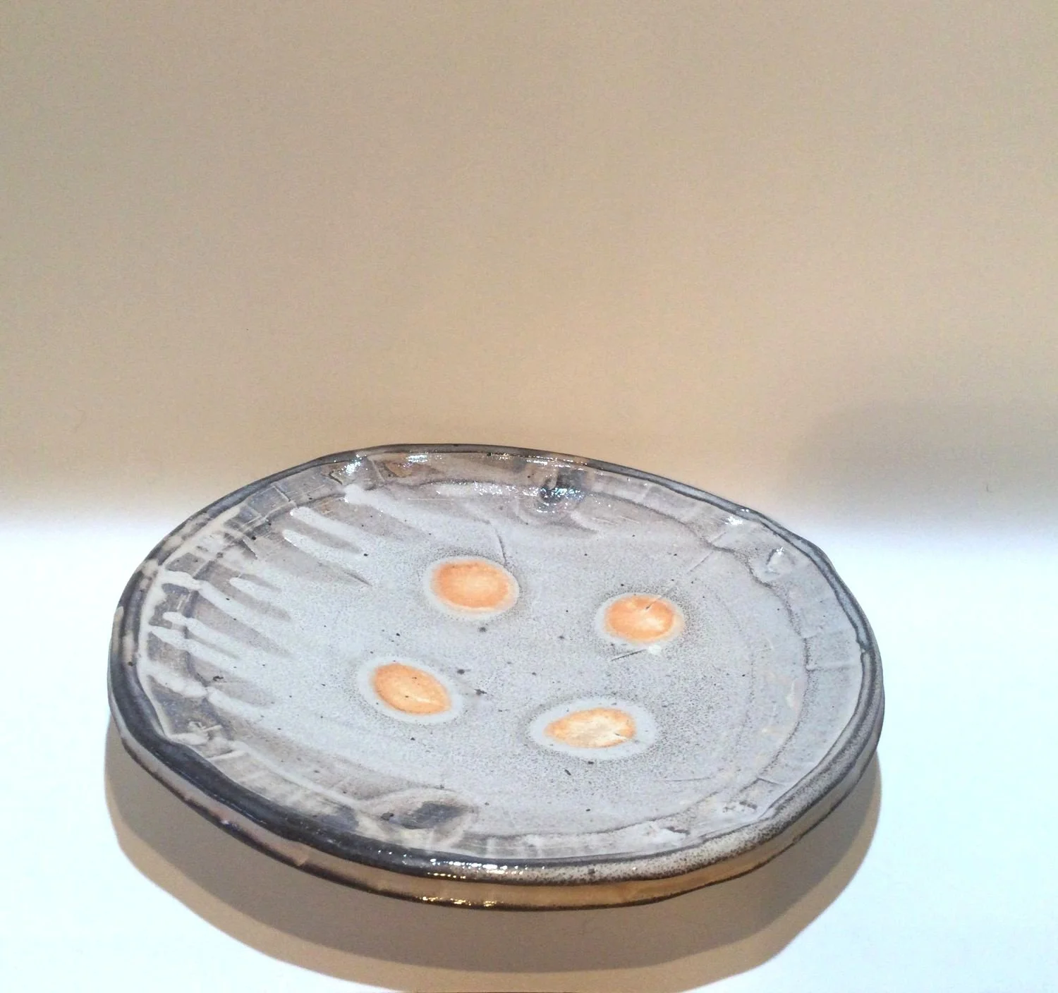 Confluence Side Plate (#26.2.45), 2026, low soda-fired earthenware, 1.25 x 7.5 x 7.5  inches (3 x 19 x 19 cm), $80 Cdn.