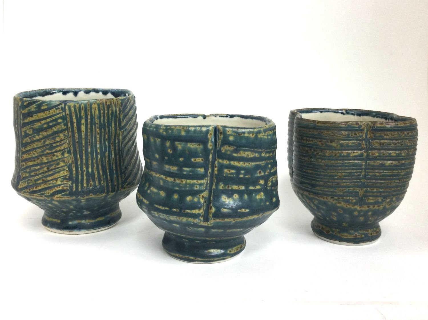 Reduction Fired Tea Bowls (#26.6.34abc), 2026, reduction fired porcelain, 4 - 3.5 inches (10 - 9 cm) high, $40 Cdn each