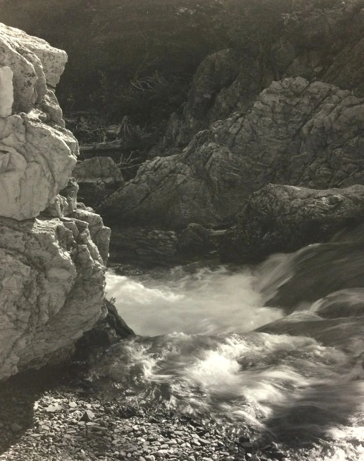 Cameron Creek Rapids (#216), 1984, dark-room based silver emulsion black & white photograph, 14 x 11 inches (35.5 x 28 cm), framed,  ($825 Cdn, category D).