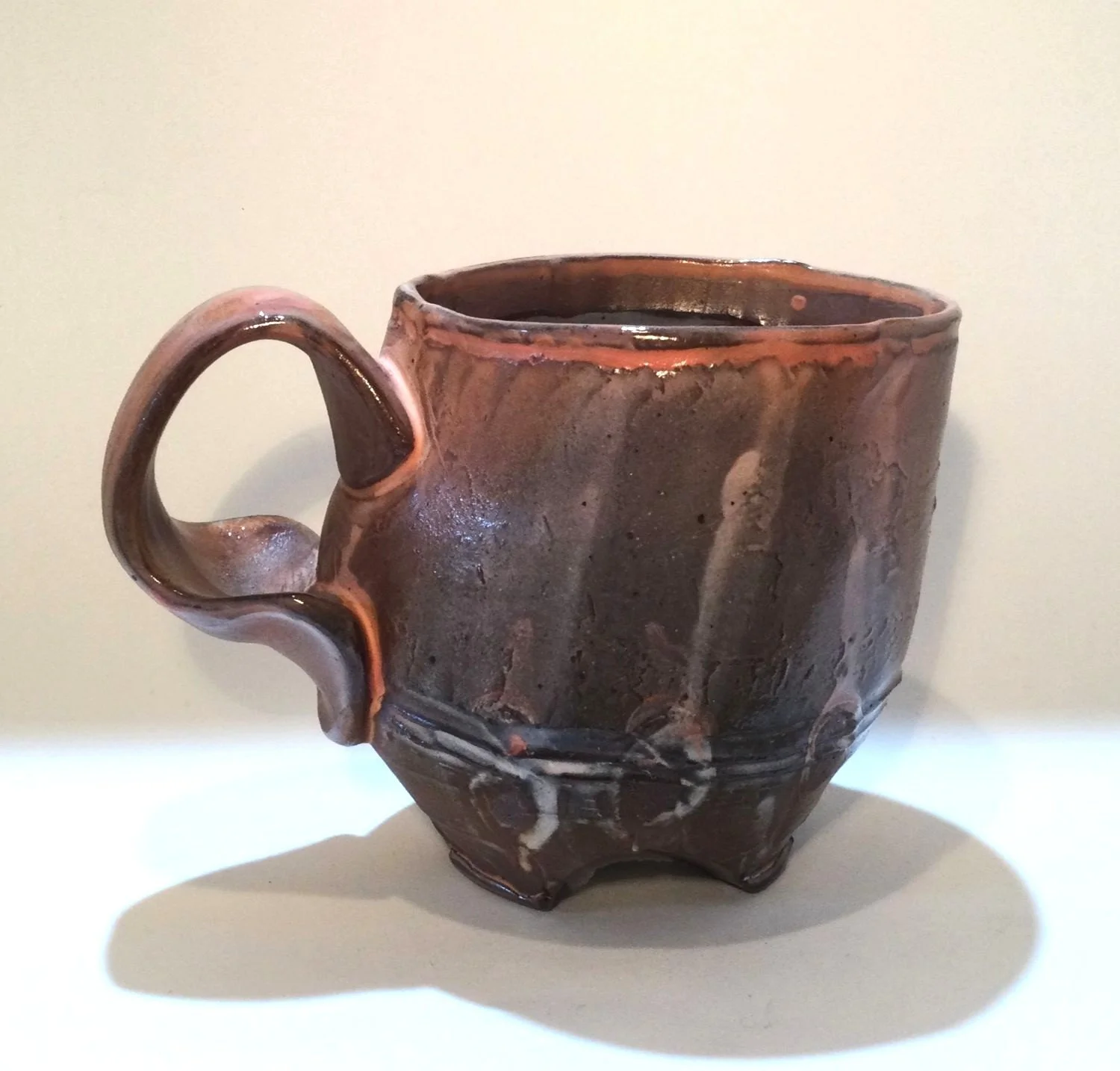 Confluence - Footed Mug (#26.2.83), 2026, low soda-fired earthenware, 3.75 x 5 x 3.5 inches (10 x 13 x 9 cm), $90 Cdn.