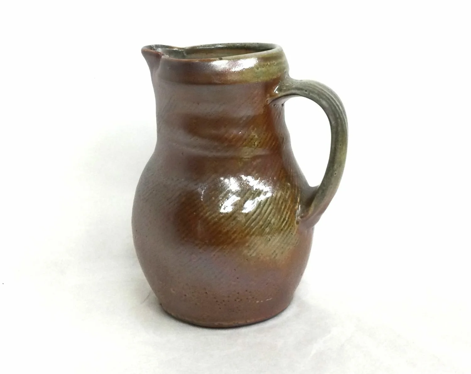Little Brown Shino Jug (#25.2.7), 2025, porcelain, 6 x 5 x 3.5 inches (15 x 12.5 x 9 cm), $45 Cdn.