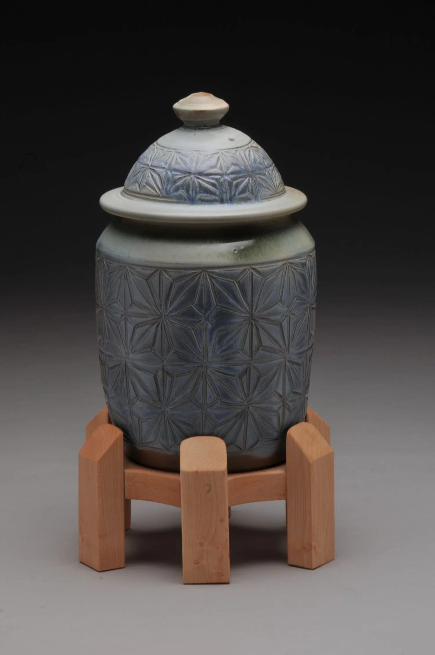 "Home" Kumiko Lidded Jar with Maple Stand (#32), 2023, hand carved stoneware & wood, overall 13 x 7 inches (33 x 18 cm), $275 Cdn.