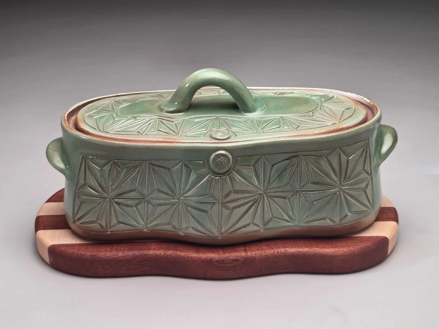Kumiko Blue Skies & Prairie Fields Casserole with Wood Trivet (lge #26.5.12a), 2026, hand carved & glazed stoneware, handcrafted wood, 5 x 6 x 11 inches (13 x 15 x 28 cm), $275 Cdn.