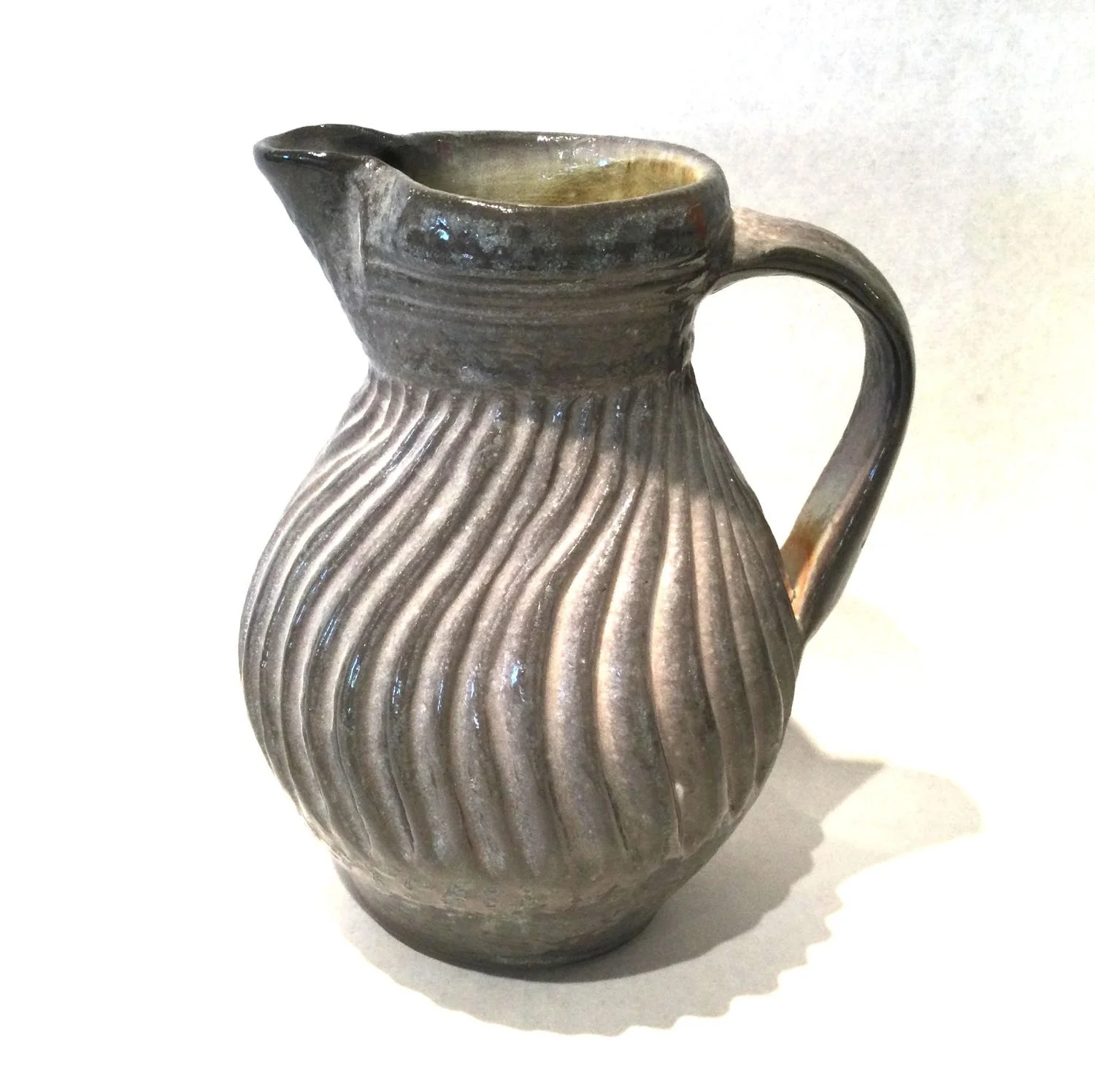 Wavy Pitcher (#25.7.4), 2025, carved porcelain, 7.25 x 5.75 x 5 inches (18.5 x 14.5 x 12.5 cm), $75 Cdn.