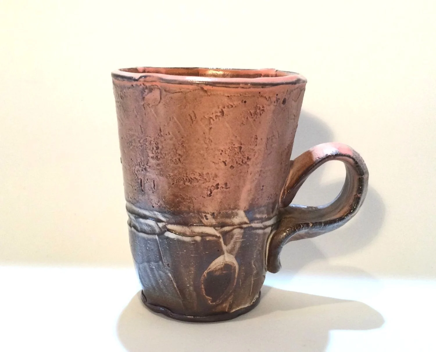 Confluence - Straight Mug (#26.2.63), 2026, low soda-fired earthenware, 4.25 x 4.75 x 3.25 inches (11 x 12 x 9 cm), $85 Cdn.