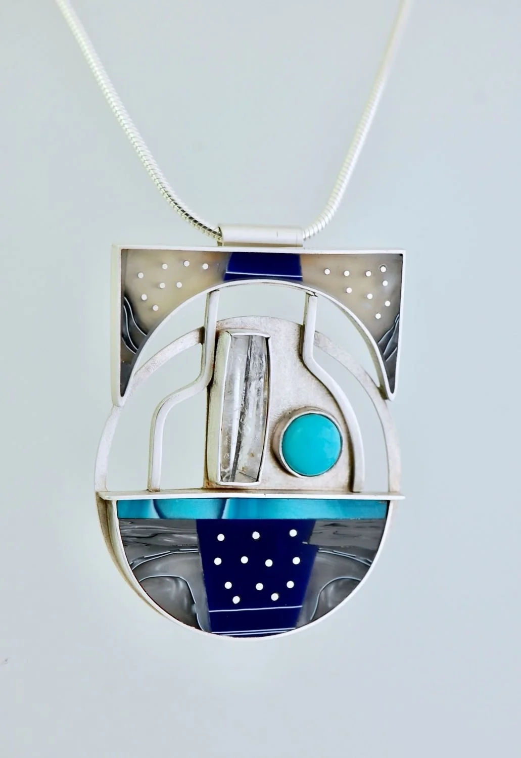 Circling Brooch/Pendant (JDA93), 2024, sterling, acrylic acetate, rutile tourmaline, turquoise, 2 x 2.5 x .25 inches (5 x 6.2 x 1 cm) with 14" (35.5 cm) neck wire, $1400 Cdn.