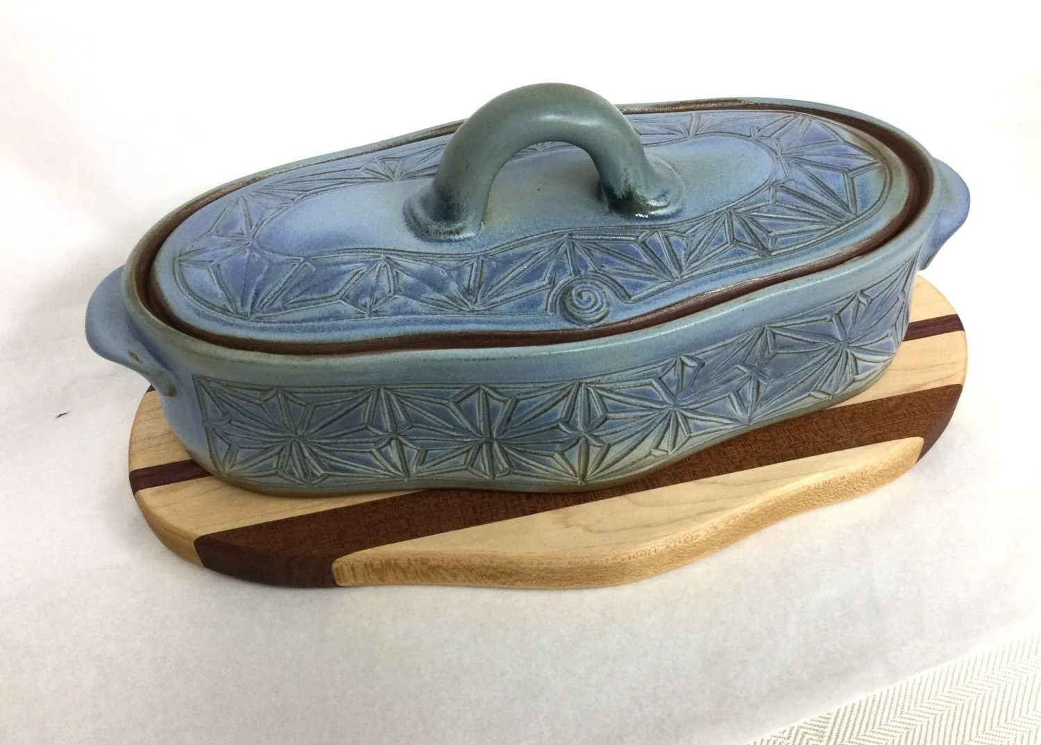 Prairie Sky Kumiko Casserole Dish with Striped Wood Trivet (#24.12.4), 2024, hand carved stoneware with handmade wood trivet, 5.75 x 6.5 x 13 inches (14.5 x 16.5 x 33 cm), $275 Cdn.