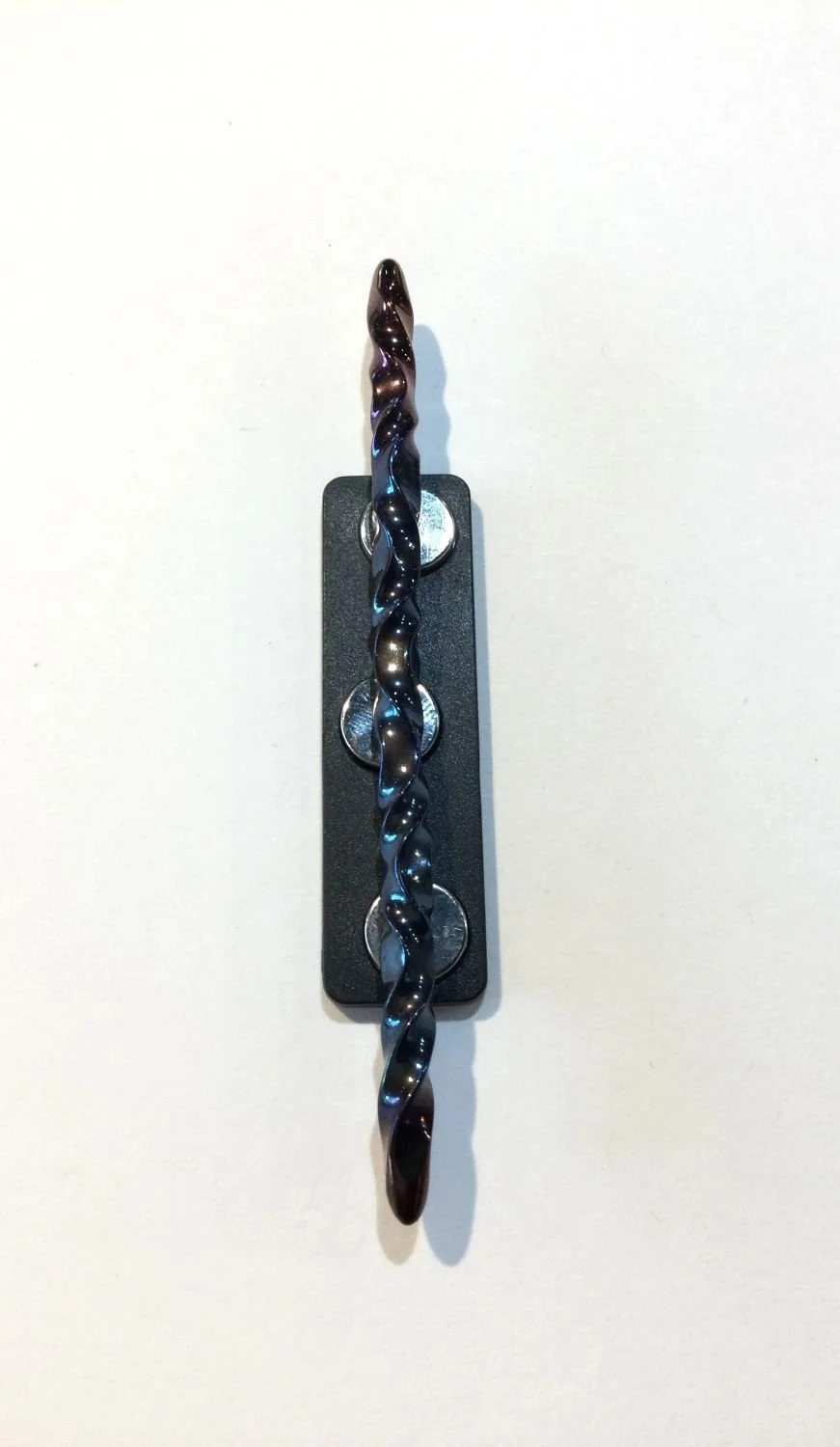 Quantum Wave Tie Pin (#0127H), 2025, steel, magnetic device, 3 x 0.15 x 0.15''/7.7 x 0.5 x 0.5cm (Including magnet: 3x0.5x0.25'' 7.7x1.5x1cm) (just magnet: 1.75x0.5'' 4.5x1.5cm), $200 Cdn.