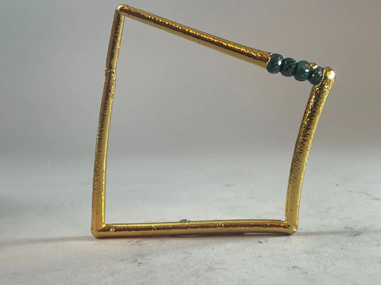 Bangle C007, 2014, fusion welded stainless steel, electroformed copper, heavy 24k gold electroforming, emeralds, 2 7/8 x 3.25 x .5 inches (7.3 x 8.3 x .6 cm), sold.