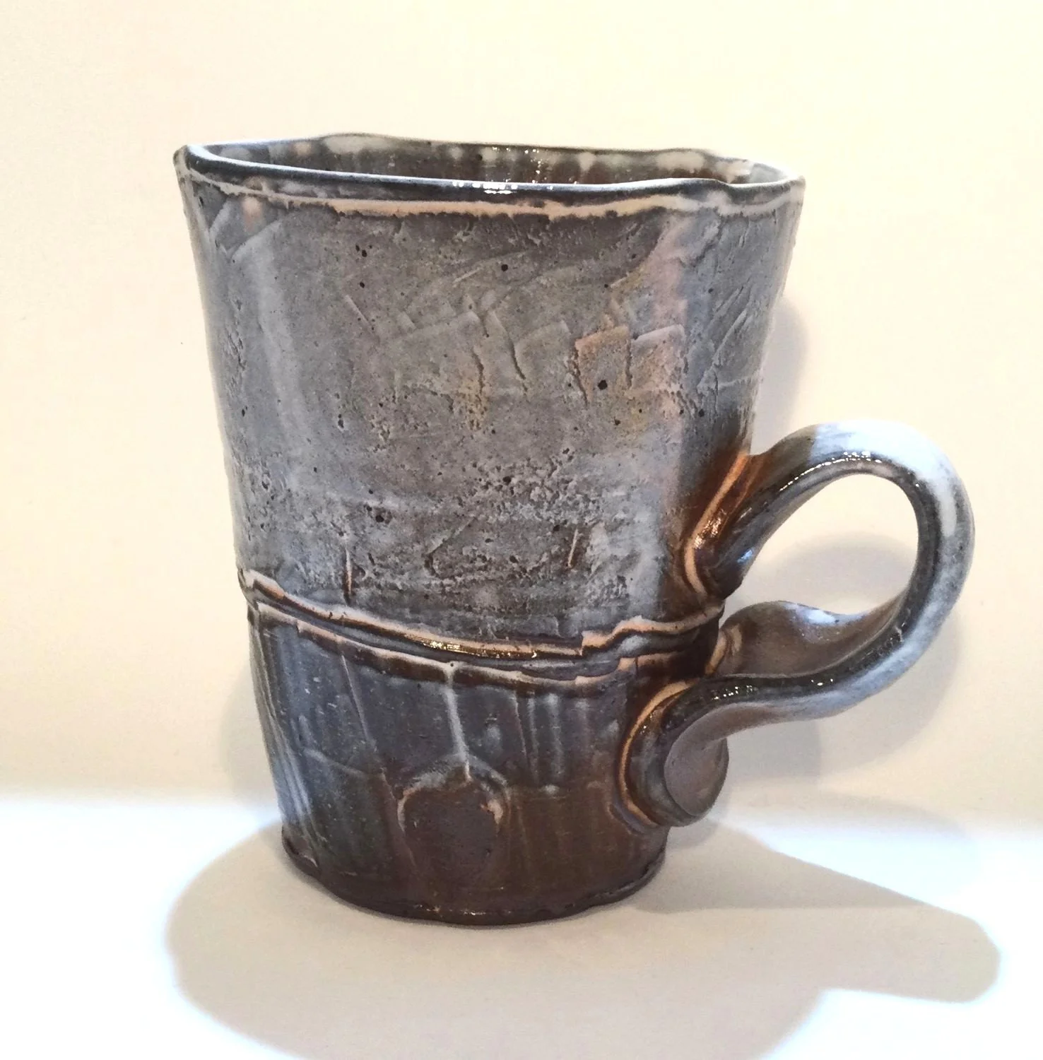 Confluence - Straight Mug (#26.2.61), 2026, low soda-fired earthenware, 4.25 x 4.75 x 3.25 inches (11 x 12 x 9 cm), $85 Cdn.