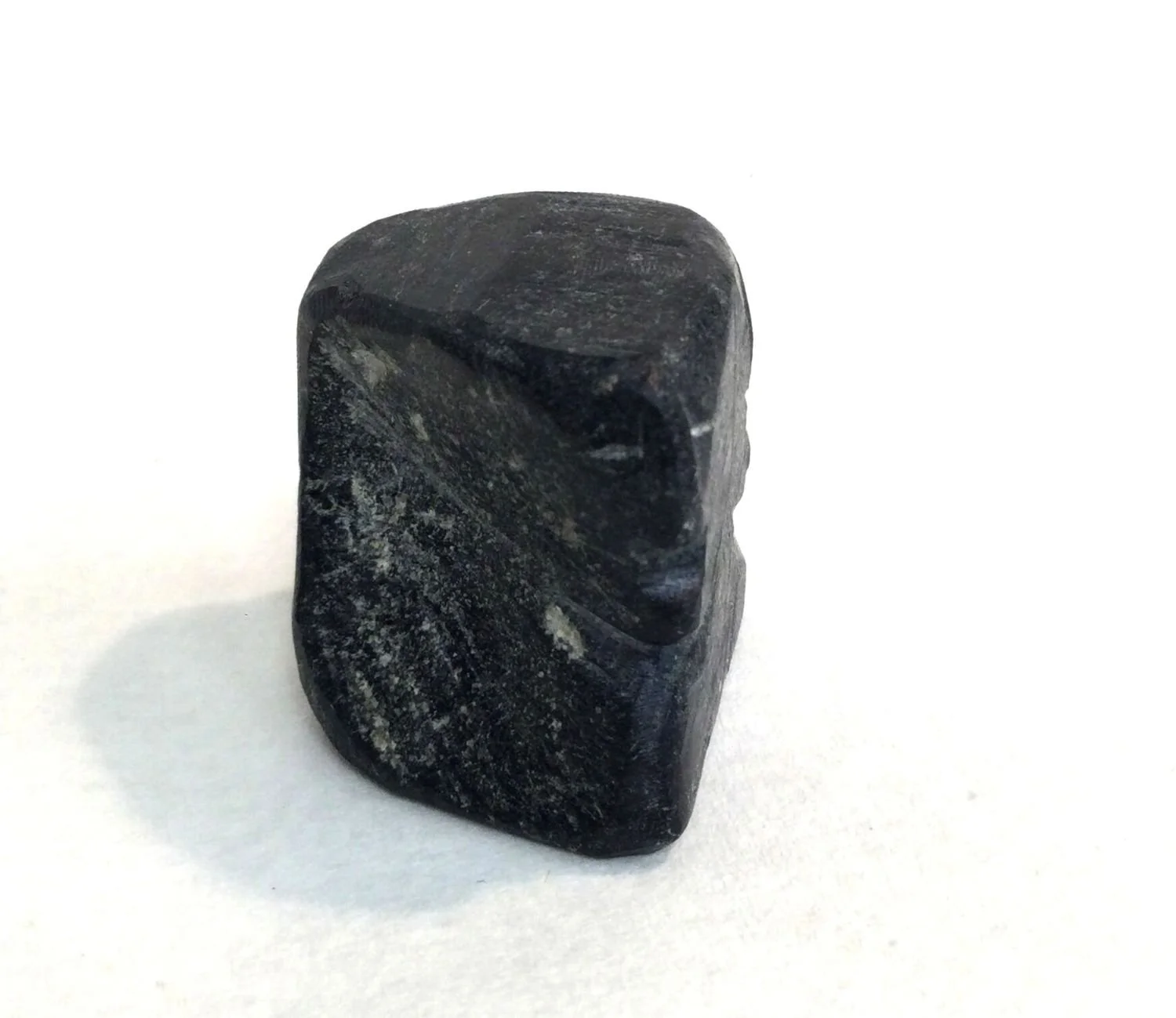 Lucy Tasseor Tutsweetok ᓗᓯ ᑕᓯᐅ ᑎᓯᑕ (1934-2012) Arviat/Eskimo Point ᐊᕐᕕᐊᑦ , Faces (#25.11.56), c.1974, basalt, 1 x 1.25 x 1 inches (2.5 x 3.5 x 2.5 cm), $350 Cdn.