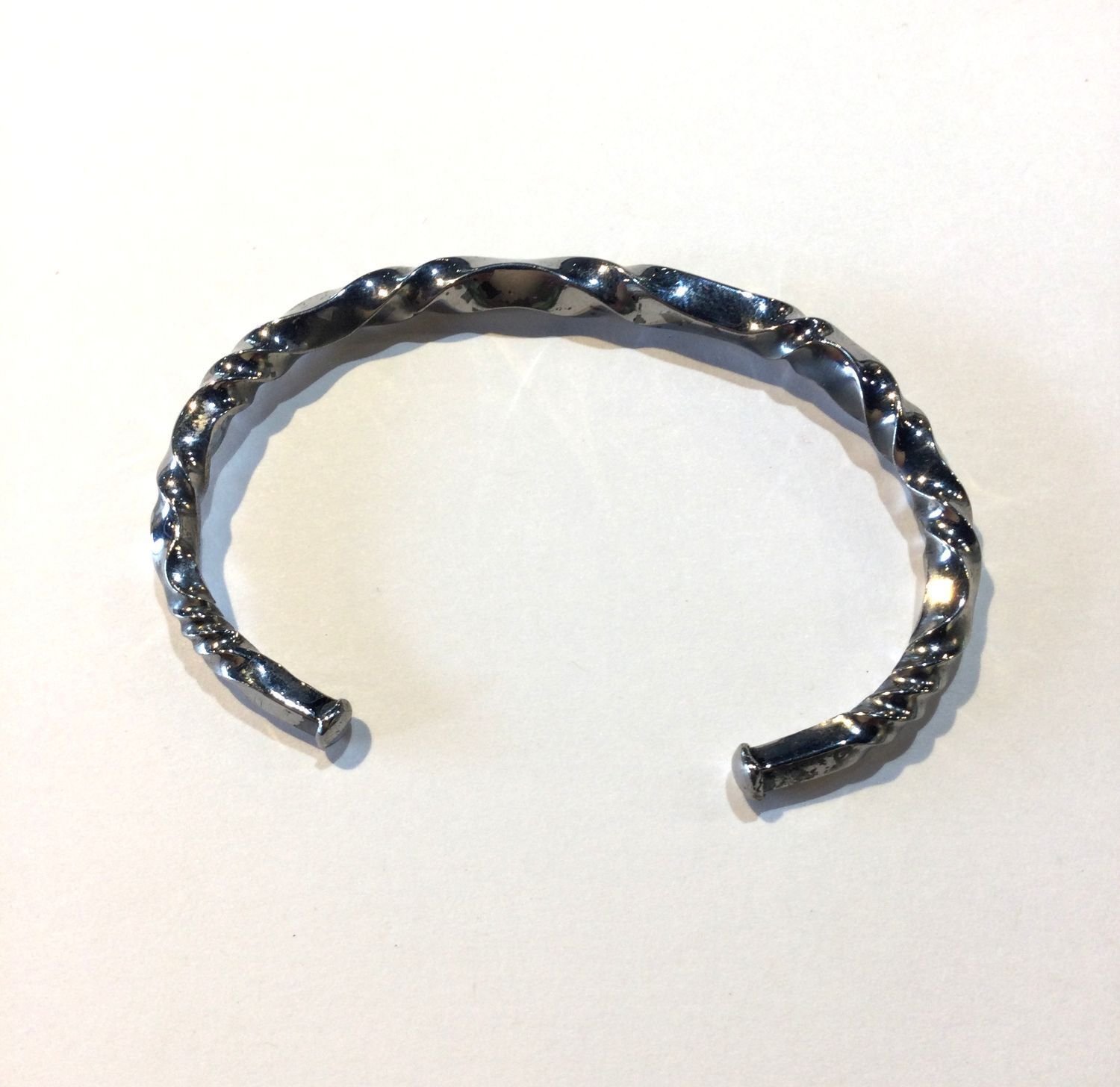 Quantum Wave Bracelet (#244D), 2024, twisted steel, 2.913 x 1.969 x 0.118 inches (7.4 x 5 x 0.3cm), $420 Cdn.