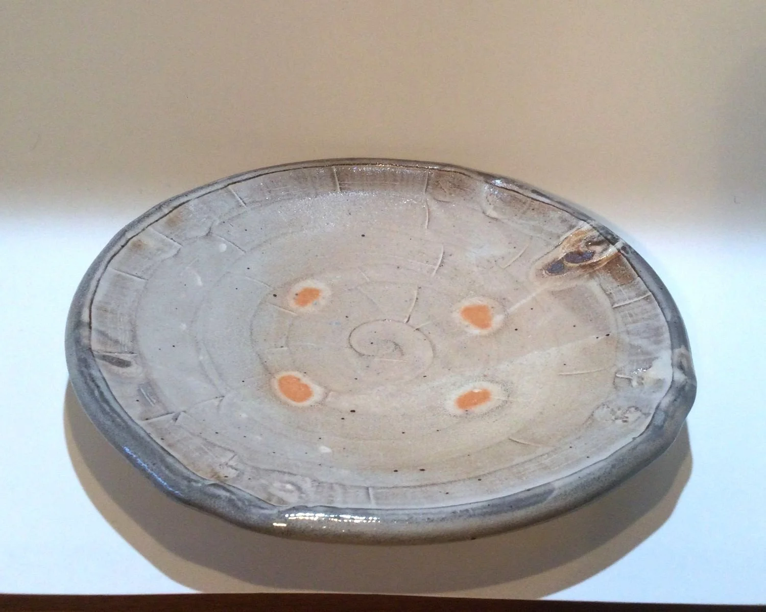 Confluence Side Plate (#26.2.44), 2026, low soda-fired earthenware, 1.25 x 7.5 x 7.5  inches (3 x 19 x 19 cm), $80 Cdn.