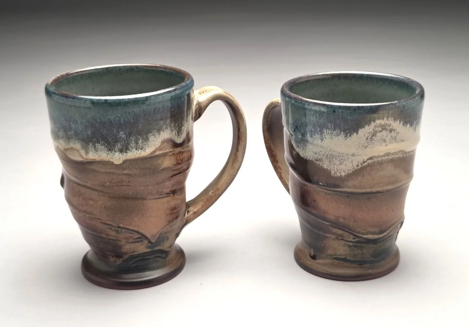 Blue Skies & Prairie Mugs (#26.18b), glazed stoneware, 5 x 5 x 3.5 inches (13 x 12.5 x 9 cm), $65 Cdn each. (#26.18a sold).
