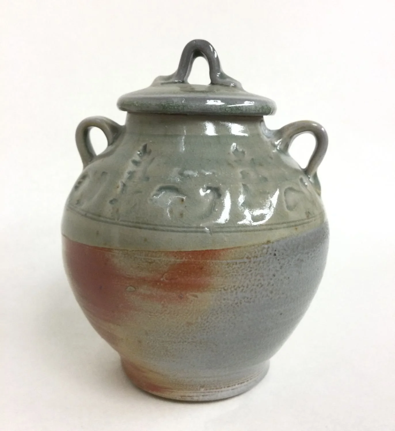 Celadon Lidded Jar (#22.4), impressed & soda fired porcelain, 7 x 5 inches (18 x 13 cm), $130 Cdn.