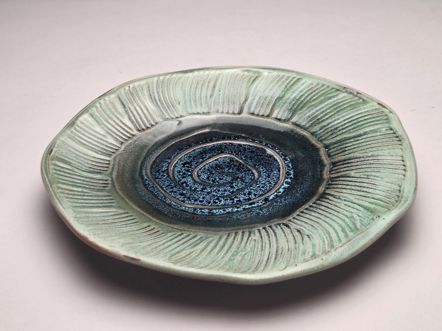 Whirlpool & Blue Sky Plate (#26.5.9), 2026, glazed stoneware, 1.25 x 9 x 9 inches (3 x 23 x 23 cm), $110 Cdn.