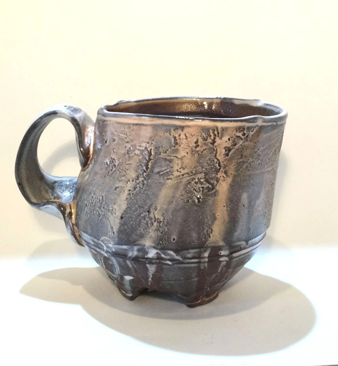 Confluence - Footed Mug (#26.2.84), 2026, low soda-fired earthenware, 3.75 x 5 x 3.5 inches (10 x 13 x 9 cm), $90 Cdn.