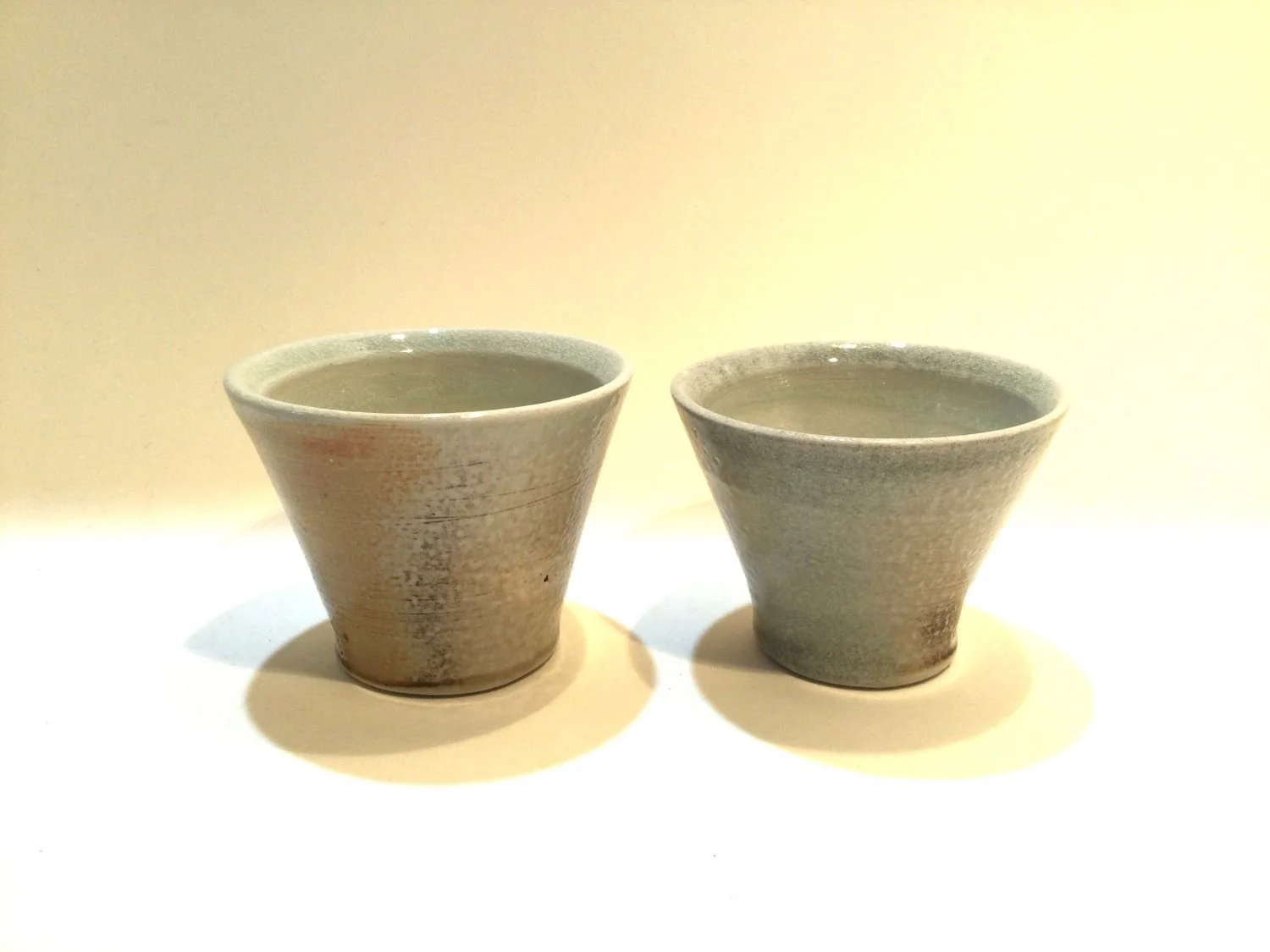 Shot Glasses (#26.7.4ab), 2026, soda fired porcelain, 2.25 x 3 inches (5.5 x 7.5 cm), $25 Cdn each