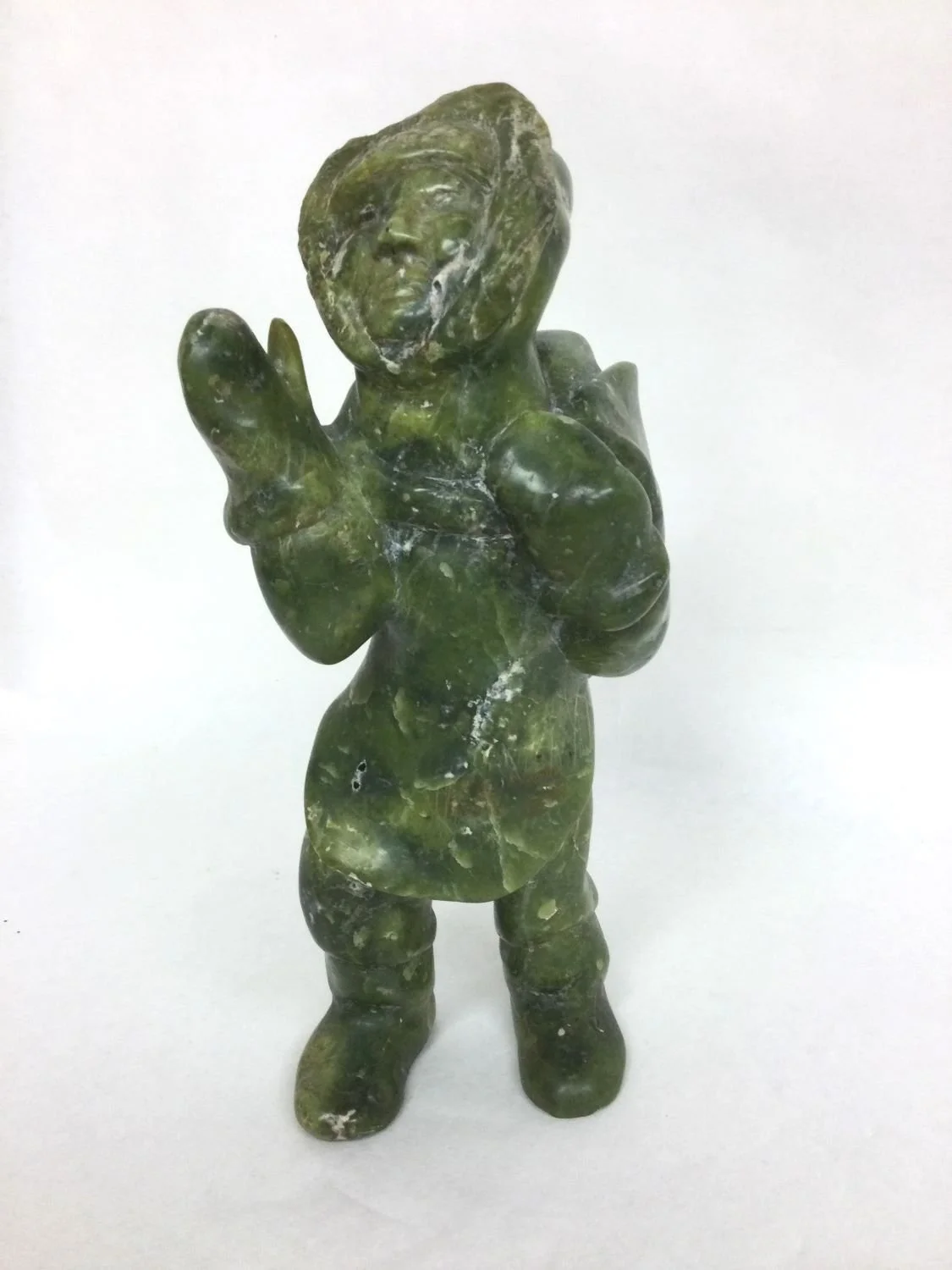 Towatuga Sagouk (E7-826), 1934-96 Iqaluit / Frobisher Bay, ᐃᖃᓗᐃᑦ, Hunter (#25.9.20), 1970, serpentine, 9.25 x 5 x 3.5 inches (23.25 x 12.5 x 9 cm), signed in syllabics, provenance: BC Collection, $1250 Cdn.