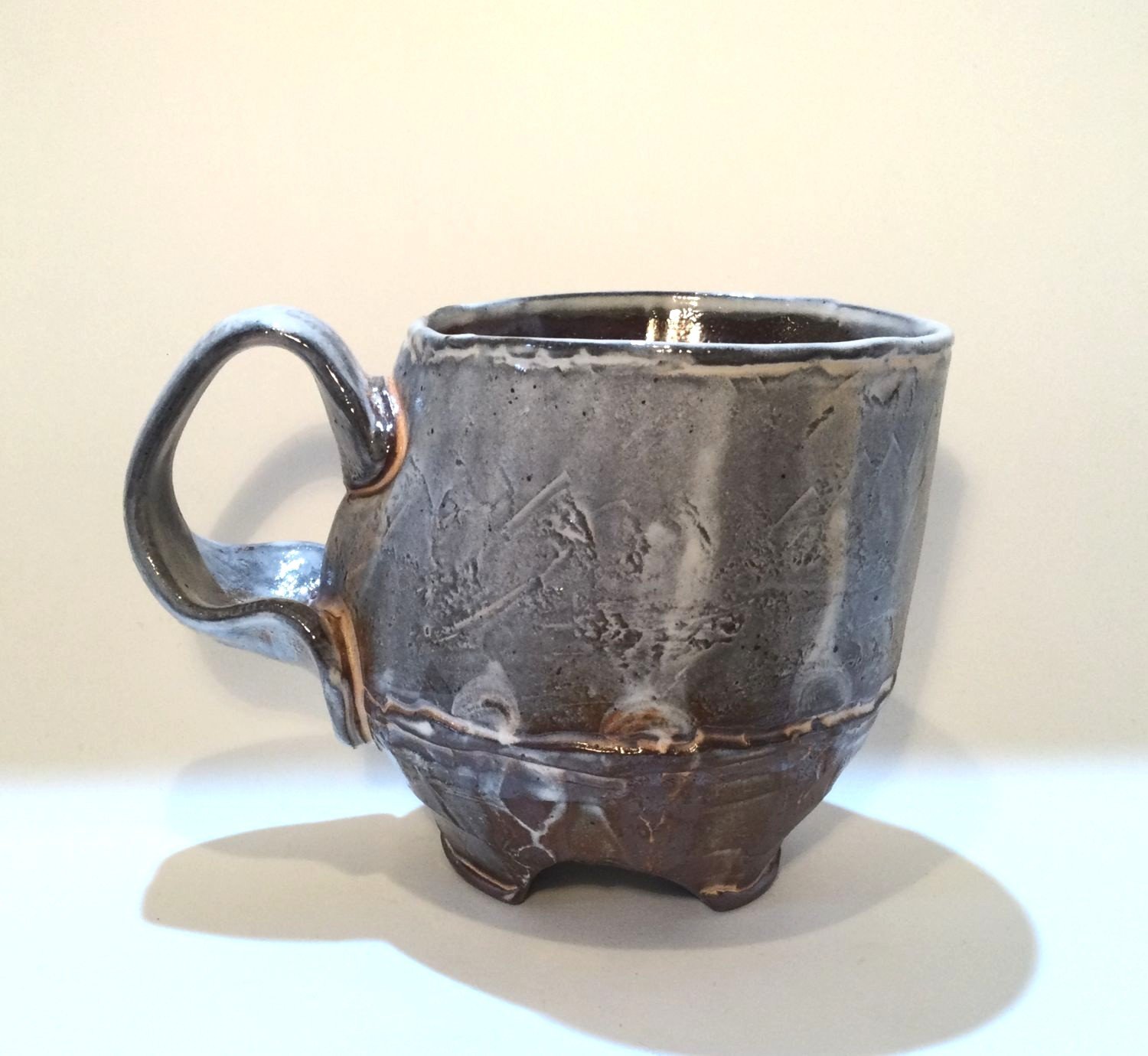 Confluence - Footed Mug (#26.2.87), 2026, low soda-fired earthenware, 3.75 x 5 x 3.5 inches (10 x 13 x 9 cm), $90 Cdn.