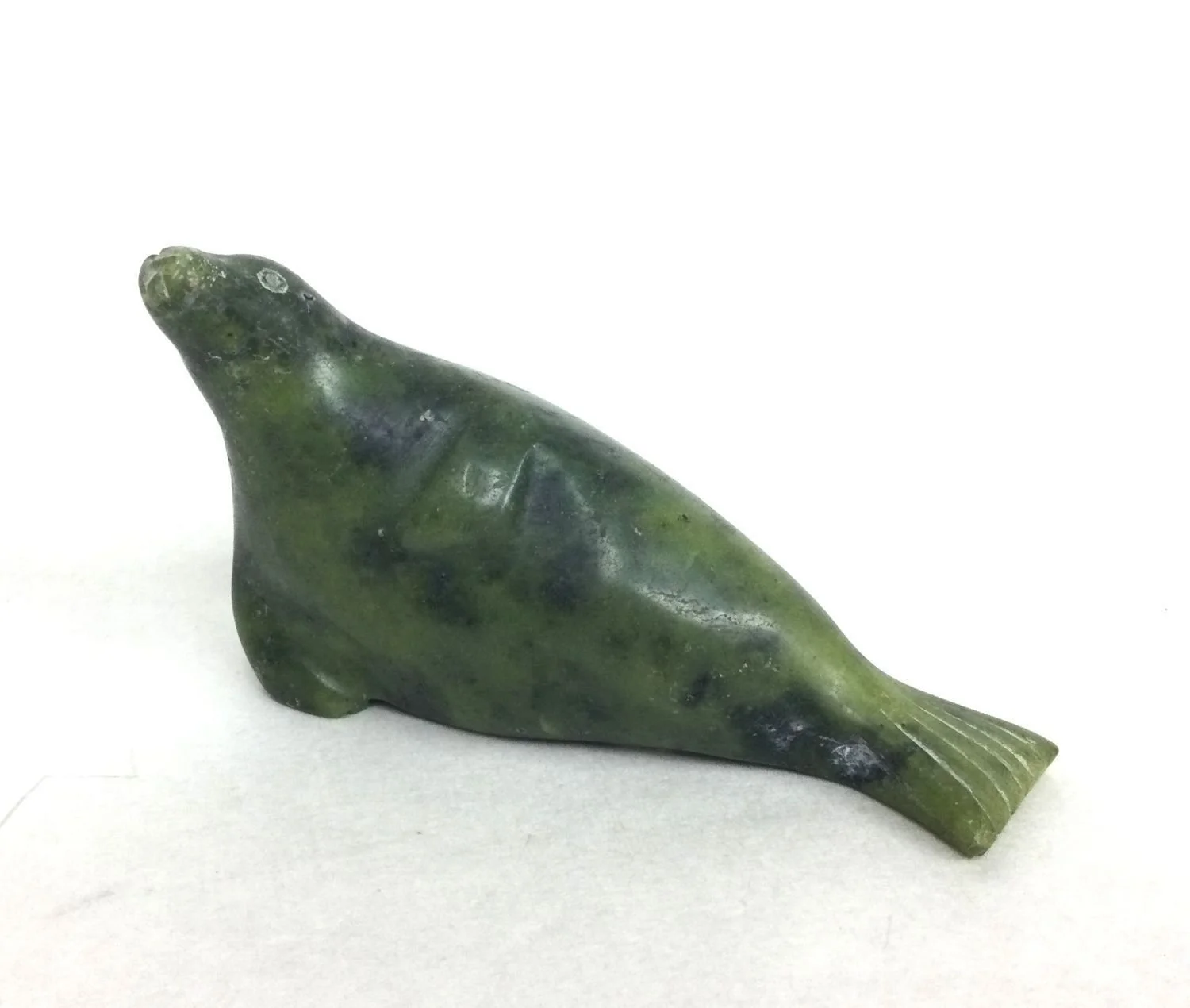 Appa Josephie (1945-) Kimmirut / Lake Harbour ᑭᒻᒥᕈᑦ, Resting Seal (#26.1.7), 1985, serpentine, 2.5 x 4.5 x 1.25 inches (6.5x11.5x3 cm), provenance: private collection BC, $450 Cdn.