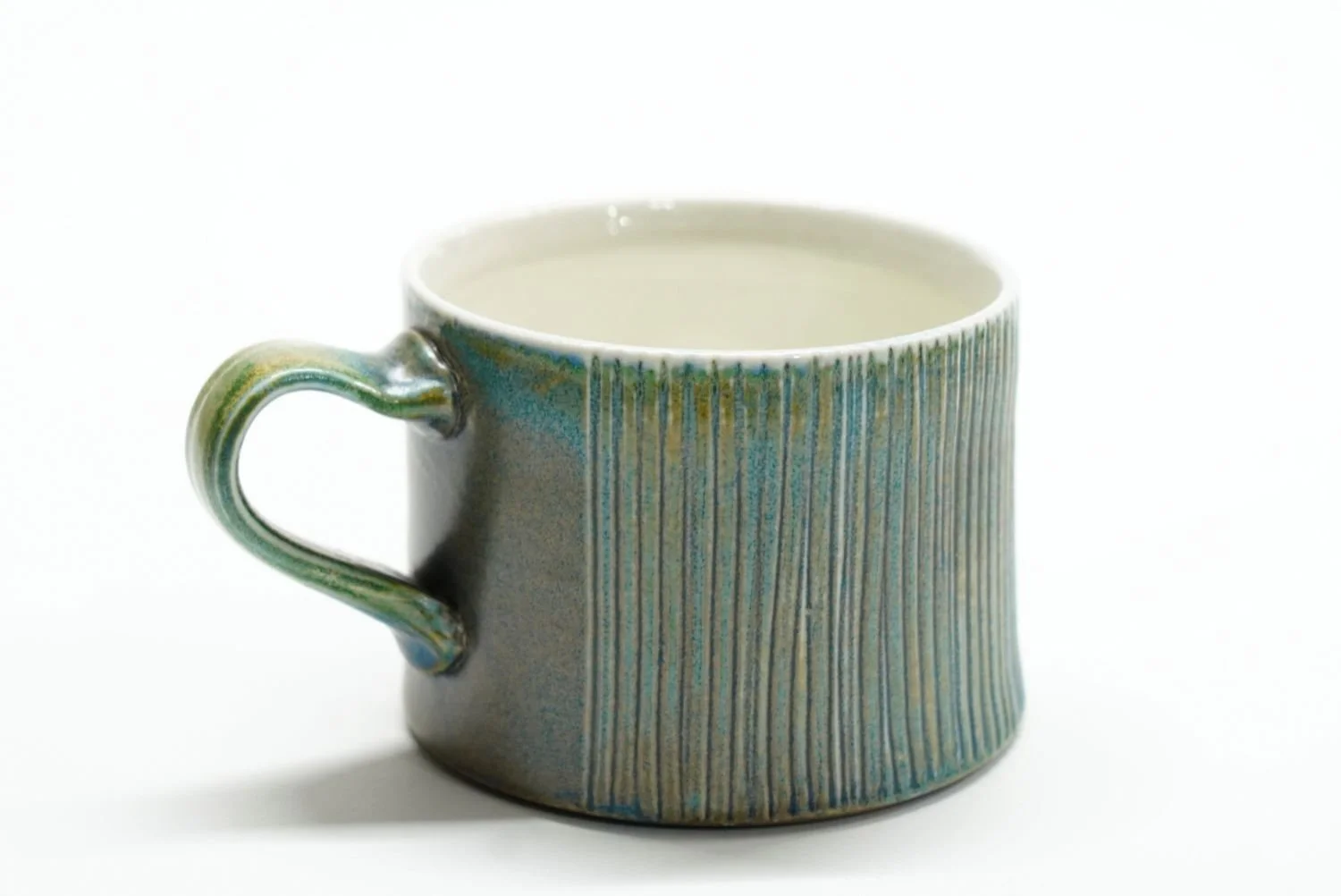 Espresso Cup (#25.64), 2025, soda fired porcelain, 2.25 x 3 x 4" (5.5 x 7.5 x 10 cm) $40 Cdn.
