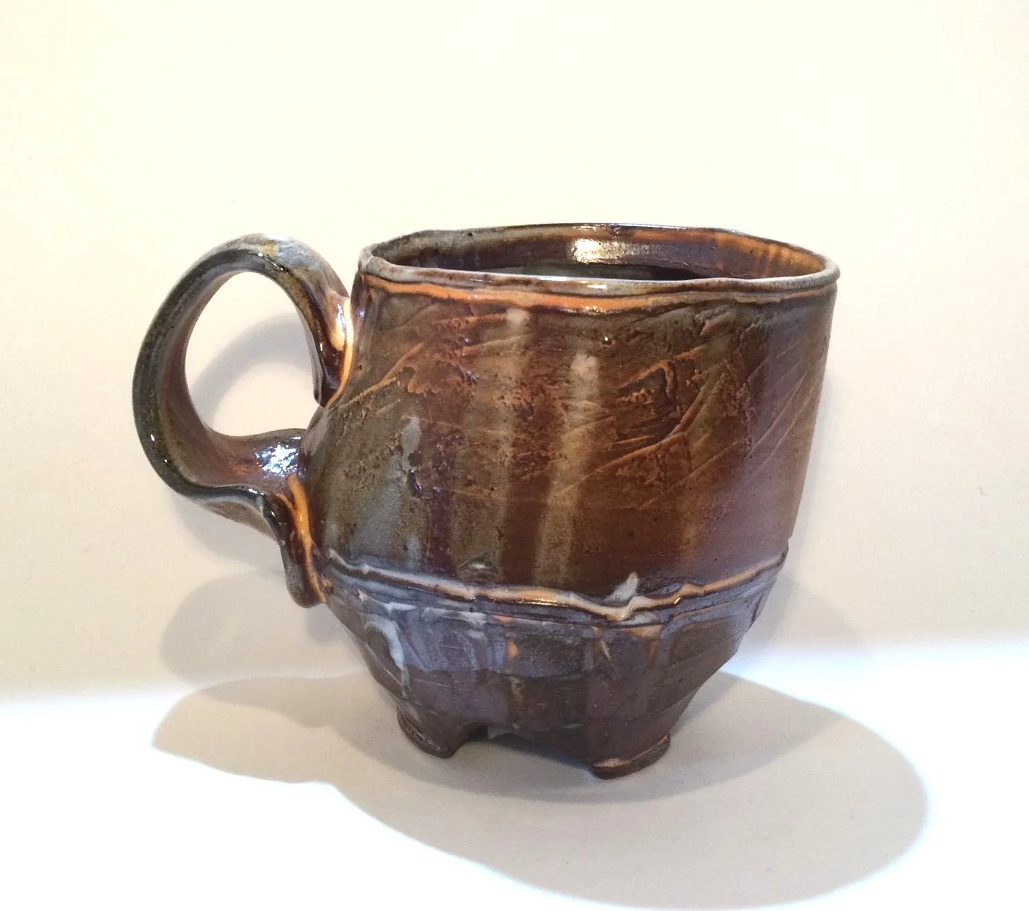 Confluence - Footed Mug (#26.2.85), 2026, low soda-fired earthenware, 3.75 x 5 x 3.5 inches (10 x 13 x 9 cm), $90 Cdn.