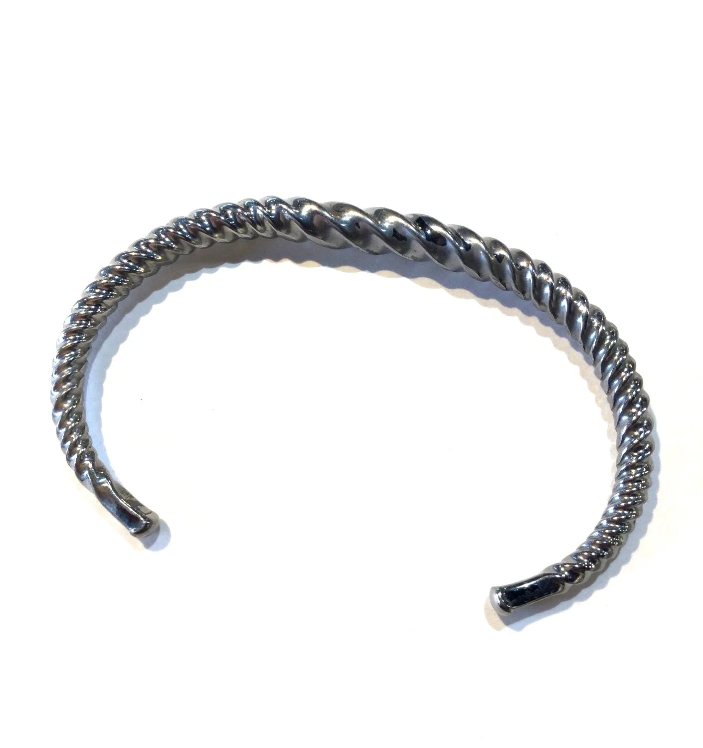 Quantum Wave Bracelet (#244G), 2024, twisted steel, 2.913 x 1.969 x 0.118 inches (7.4 x 5 x 0.3cm), $420 Cdn.