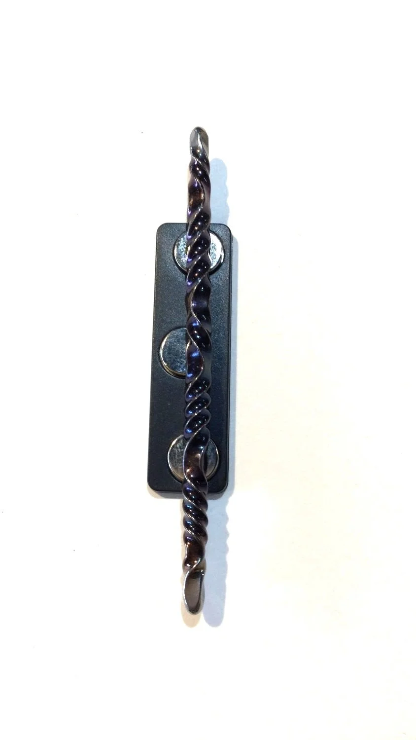 Quantum Wave Tie Pin (#0127B), 2025, steel, magnetic device, 3 x 0.15 x 0.15''/7.7 x 0.5 x 0.5cm (Including magnet: 3x0.5x0.25'' 7.7x1.5x1cm) (just magnet: 1.75x0.5'' 4.5x1.5cm), $200 Cdn