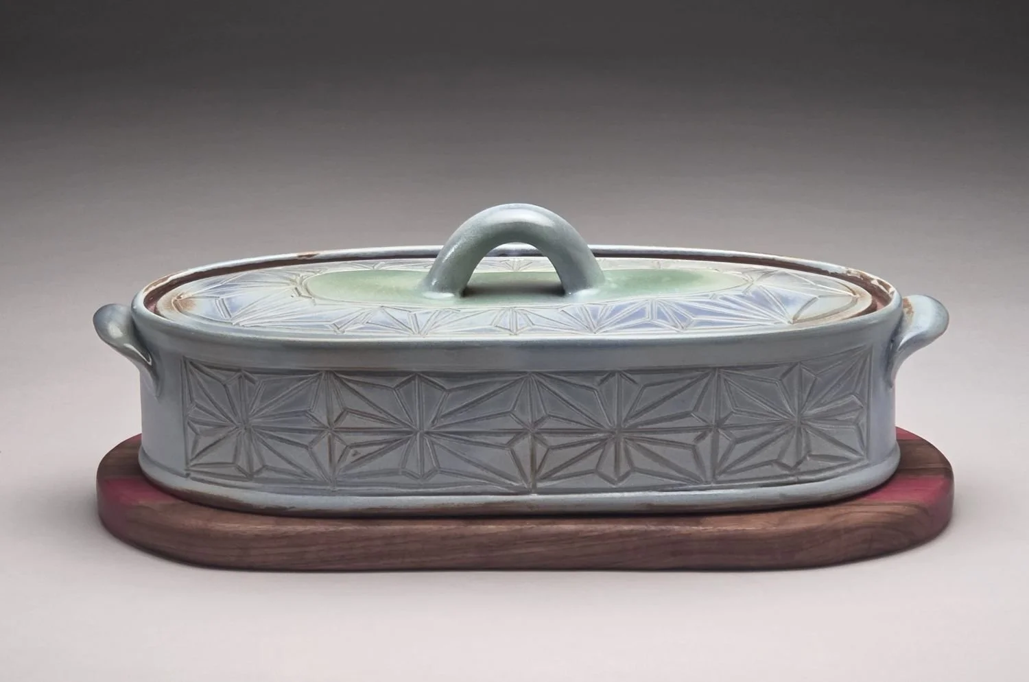 Kumiko Blue Skies & Prairie Water Casserole with Wood Trivet (lge #26.5.12b), 2026, hand carved & glazed stoneware, handcrafted wood, 4 x 6 x 14 inches (10 x 15 x 35.5 cm), $275 Cdn.
