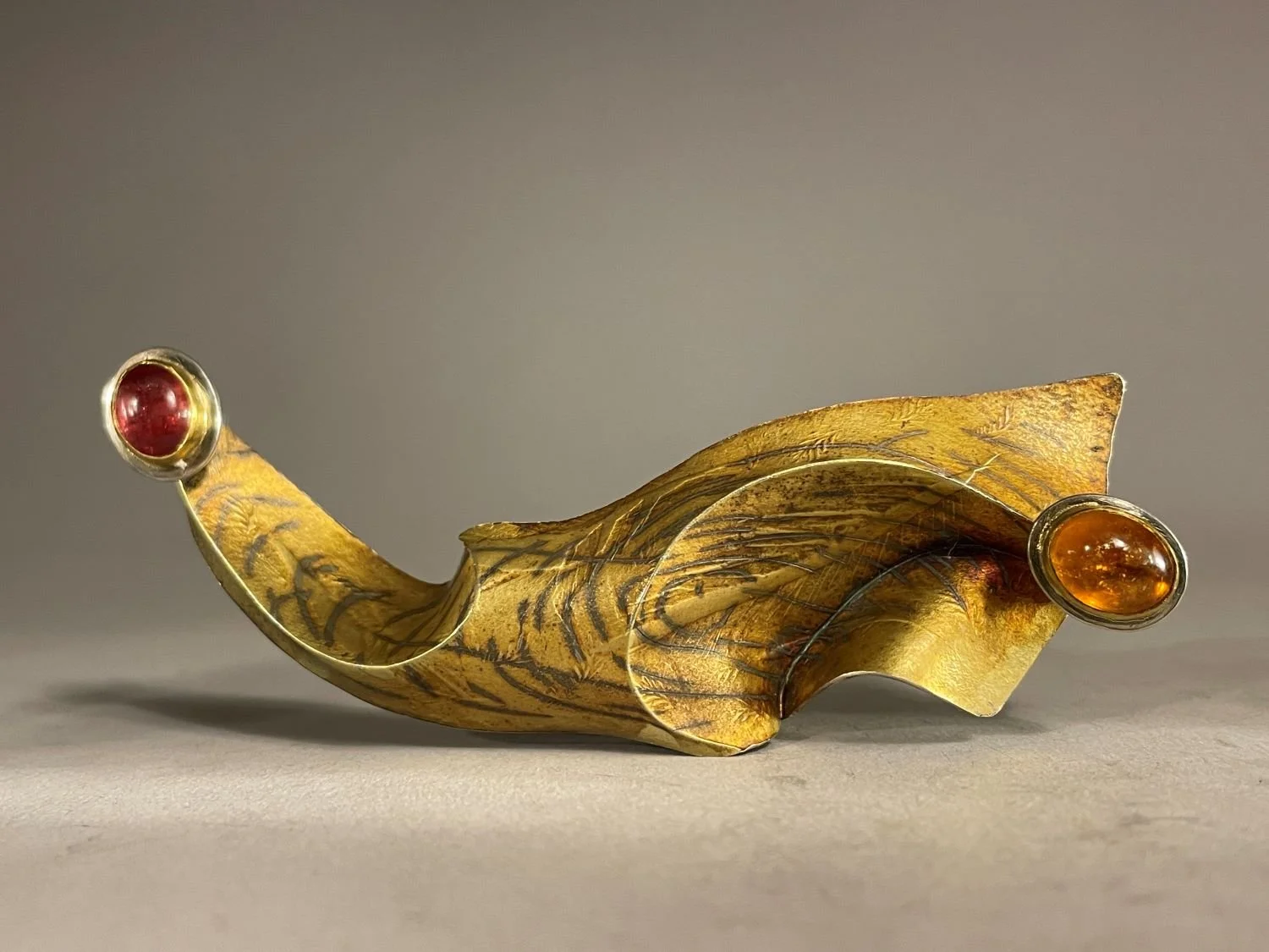 “Sedna in the Foam” Brooch (Swoop Series), 1994, materials 18k gold laminate, sterling, 24k bezels, yellow oval tourmaline, pink oval tourmaline, (10.4x3.5x2 cm), $3100 Cdn.