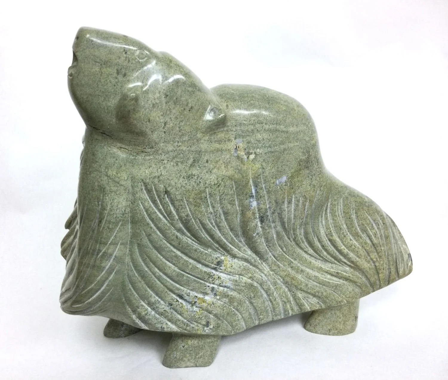 Kananginak Pootoogook ᑲᓇᖏᓈᖅ RCA (1935-2010), Cape Dorset/Kinngait, ᑭᙵᐃᑦ, MuskOx, c.1990, serpentine, 15 x 17 x 6.5 inches (37 x 49 x 15 cm), $18,000 Cdn.