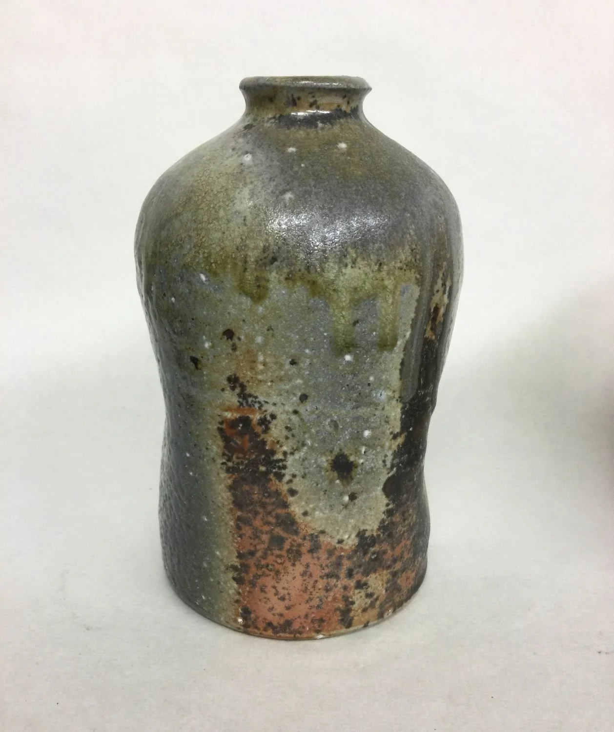 Atmospheric Fired Bottle (#25.11), 2025, woodfired porcelain, 5.75 x 3.5 inches (14.5 x 8.5 cm) sold.