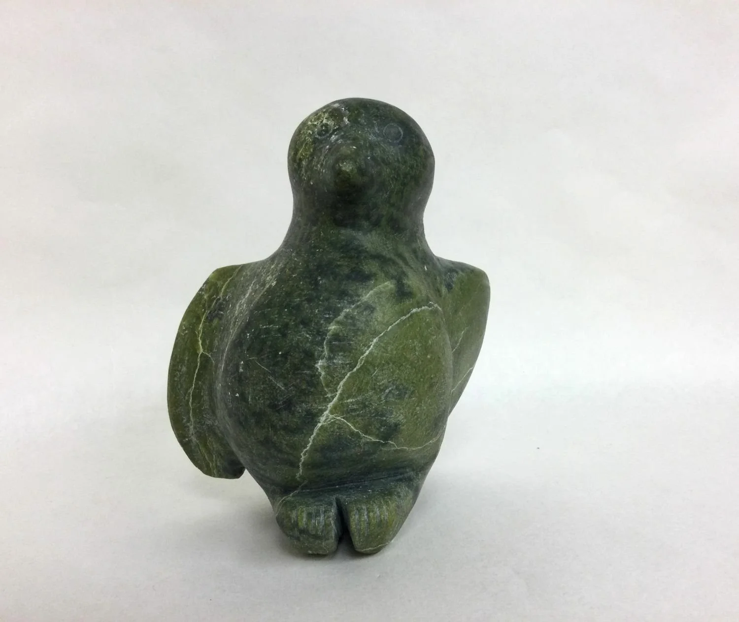 considered Tudlik E7-1050 (1890-1966) Kinngait/Cape Dorset, ᑭᙵᐃᑦ, early 1960s, serpentine, 6 x 4.5 x 3.5 inches (15 x 11 x 8.75 cm), sold.