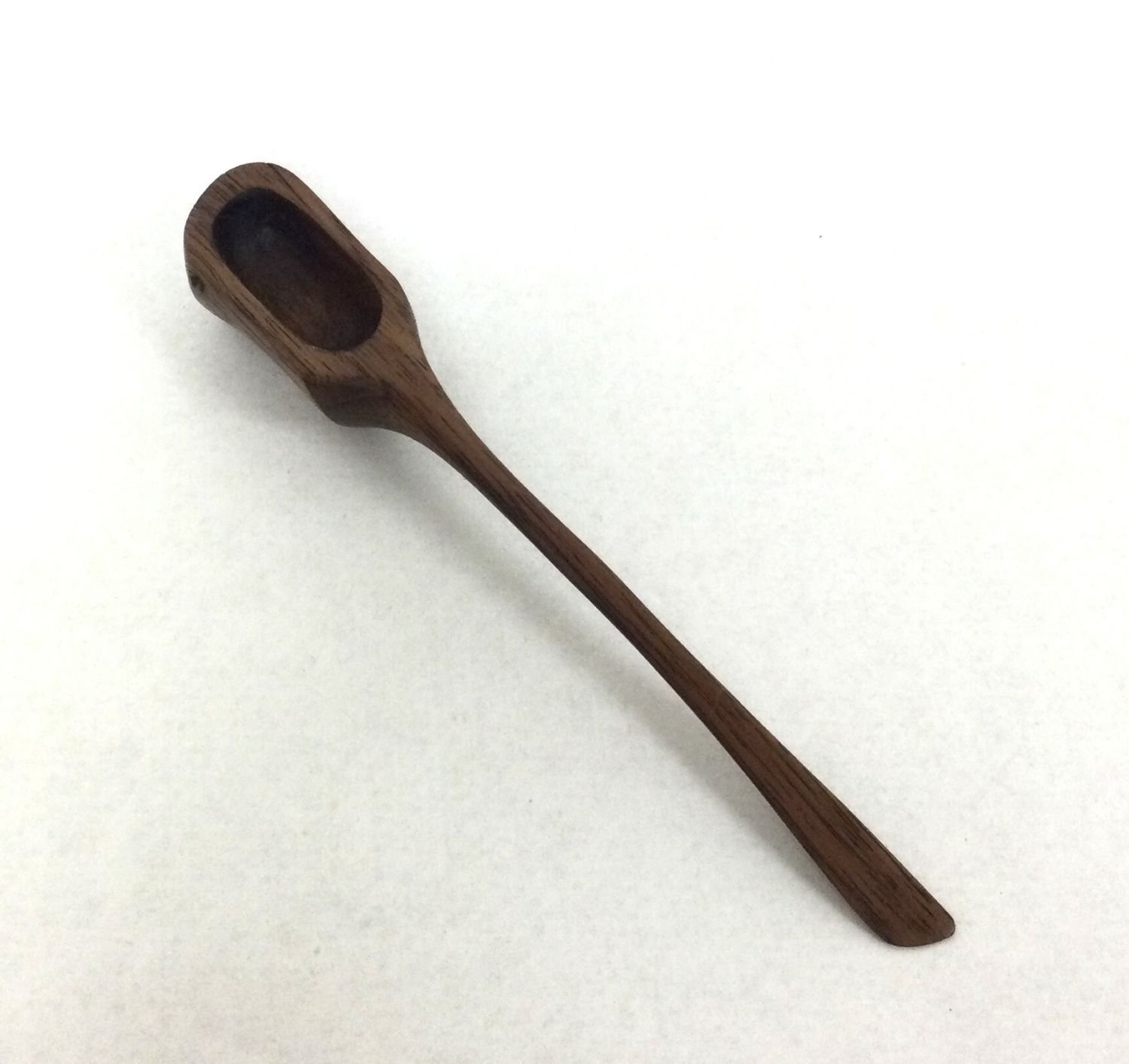 Juglans Medium Spoon (#25.12.18), 2025, chiselled and hand-sanded walnut, 5.25 x .75 x .75 inches (13x2x2 cm), $49.95 Cdn
