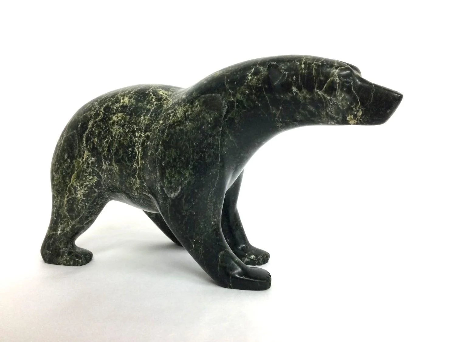 Jimmie (Jimmy) Petalassie (Petaulassie/Petauloosie), 1961-, (Kinngait/Cape Dorset, ᑭᙵᐃᑦ), Polar Bear, n.d., serpentine, 5 x 3.25 x 8.5 inches (12.5 x 8.5 x 21.5 cm), provenance: private collection BC, sold.